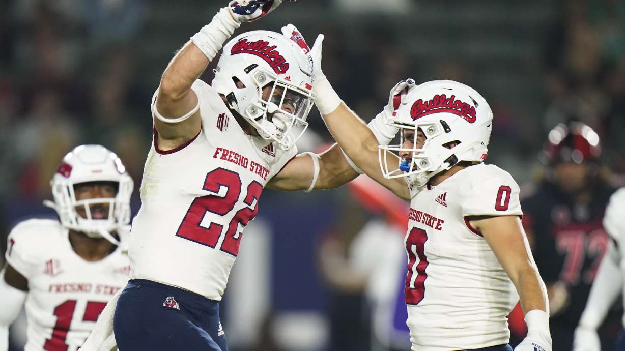 Fresno State defensive back Steven Comstock, left, celebrates his tackle with Mac Dalena during the first half of the team's NCAA college football game against Fresno State on Saturday, Oct. 30, 2021, in Carson, Calif.