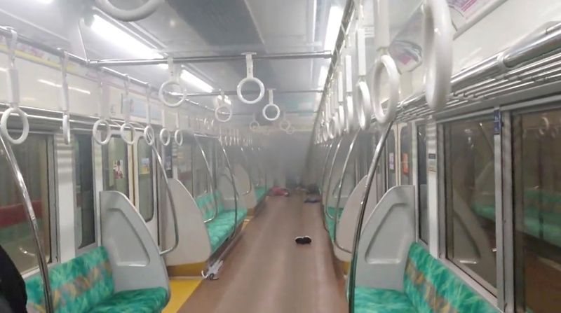 Smoke is seen in a carriage of a Tokyo train line following a knife, arson and acid attack, in Tokyo, Japan, on Sunday in this still image obtained from a social media video.