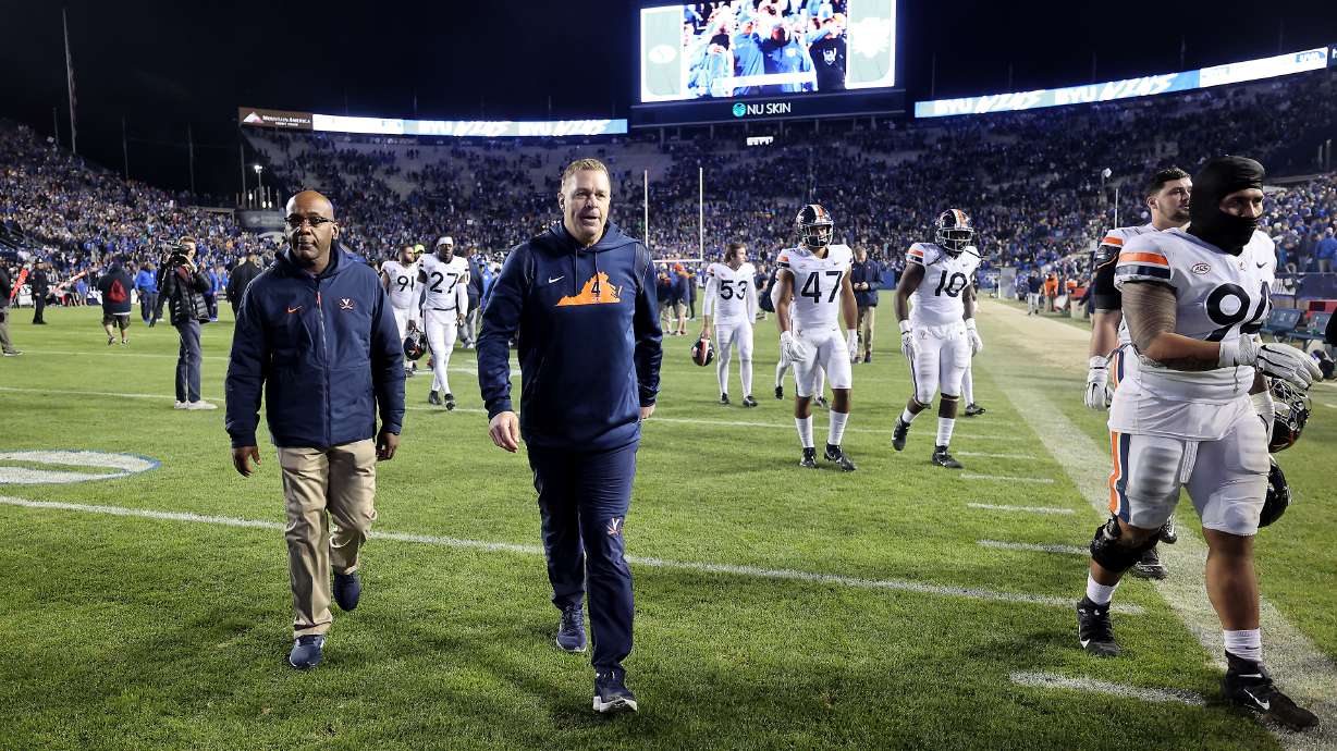 Virginia Cavaliers head coach Bronco Mendenhall walks off the field as fans cheer for him and thank him as BYU defeats Virginia at LaVell Edwards Stadium in Provo on Saturday, Oct. 30, 2021. BYU won 66-49.