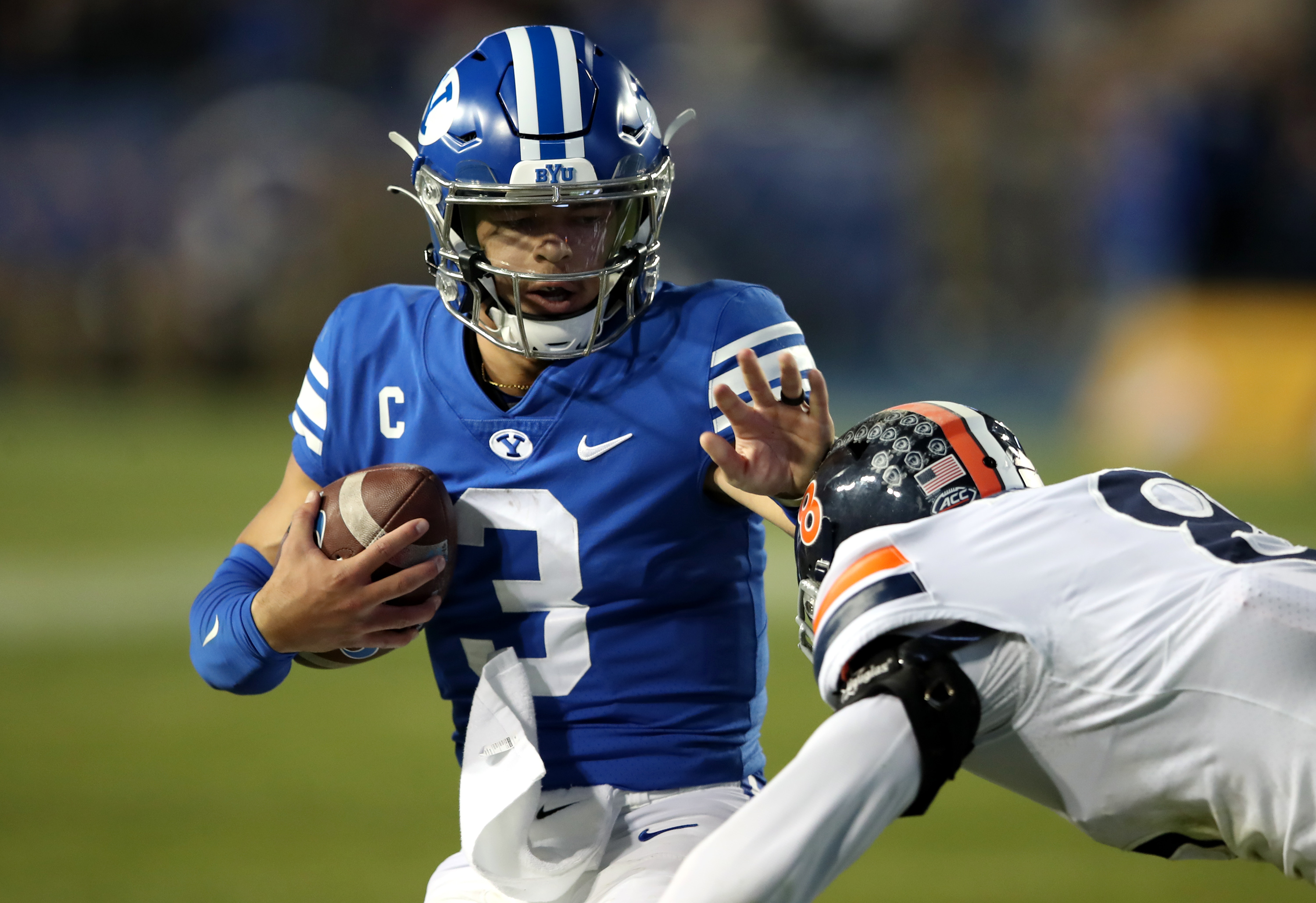 Brigham Young Cougars quarterback Jaren Hall (3) stiff-arms Virginia Cavaliers cornerback Darrius Bratton (8) as BYU and Virginia play at LaVell Edwards Stadium in Provo on Saturday, Oct. 30, 2021. BYU won 66-49.