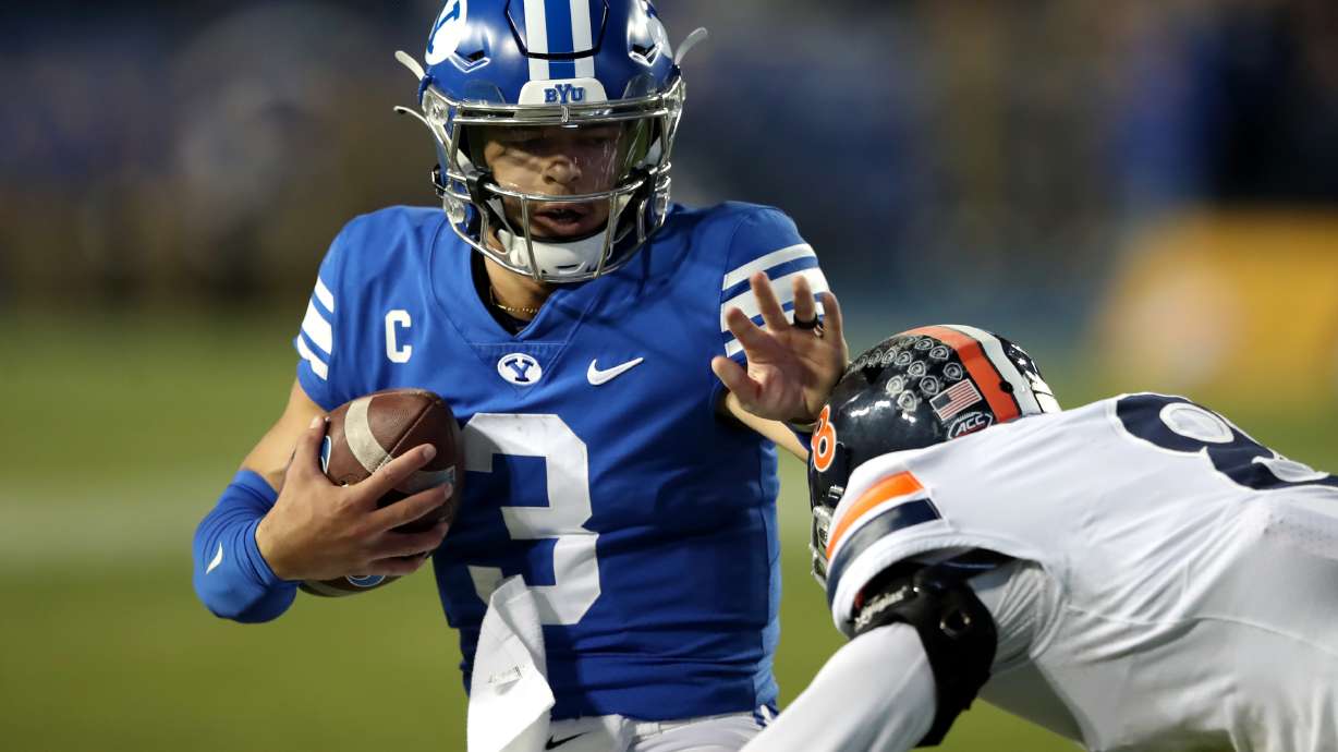 Brigham Young Cougars quarterback Jaren Hall (3) stiff-arms Virginia Cavaliers cornerback Darrius Bratton (8) as BYU and Virginia play at LaVell Edwards Stadium in Provo on Saturday, Oct. 30, 2021. BYU won 66-49.
