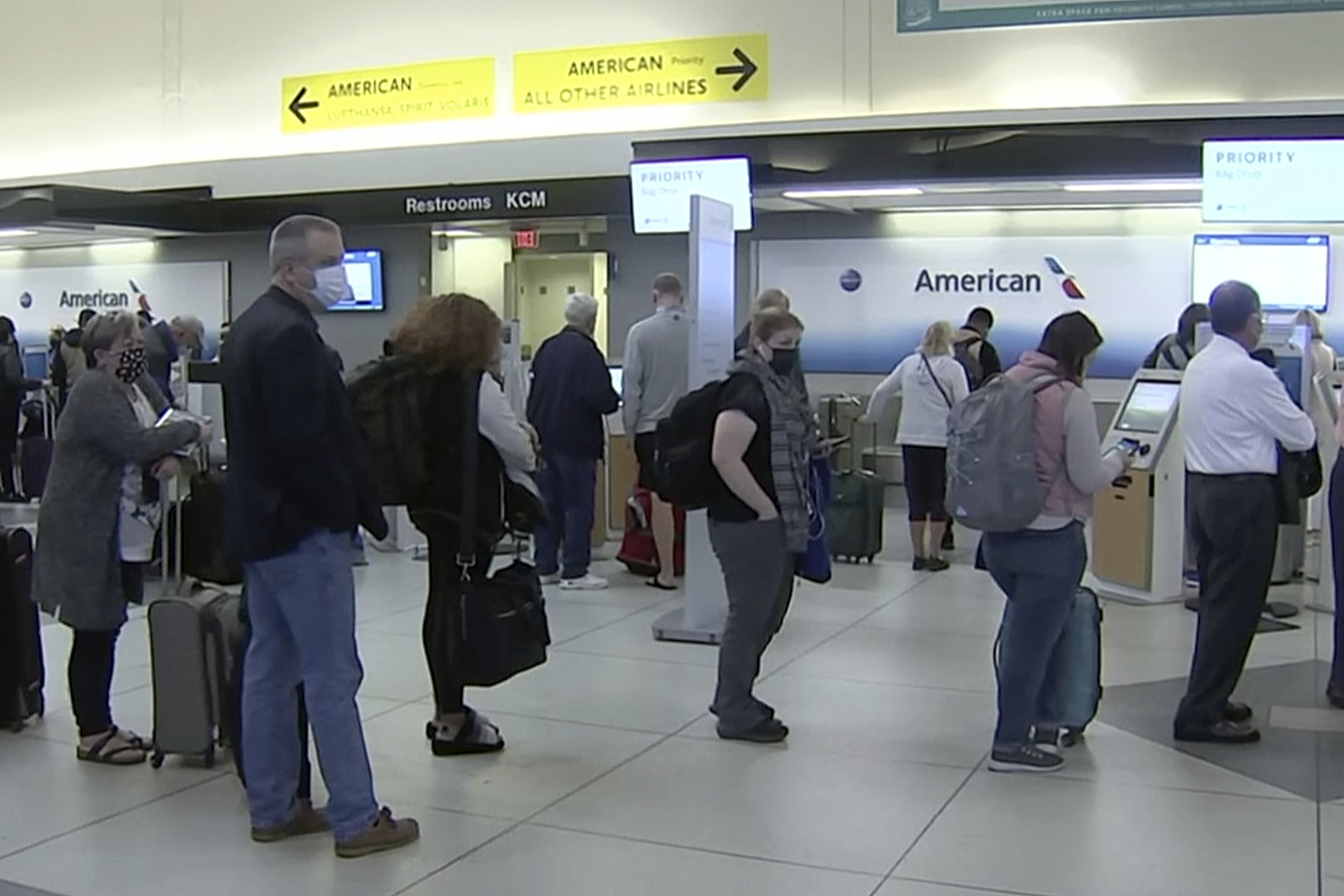 People wait in line at an American Airlines counter at an airport in Charlotte, N.C. on Sunday. The airline has canceled more than 800 flights on Sunday, or nearly 30% of its schedule for the day.