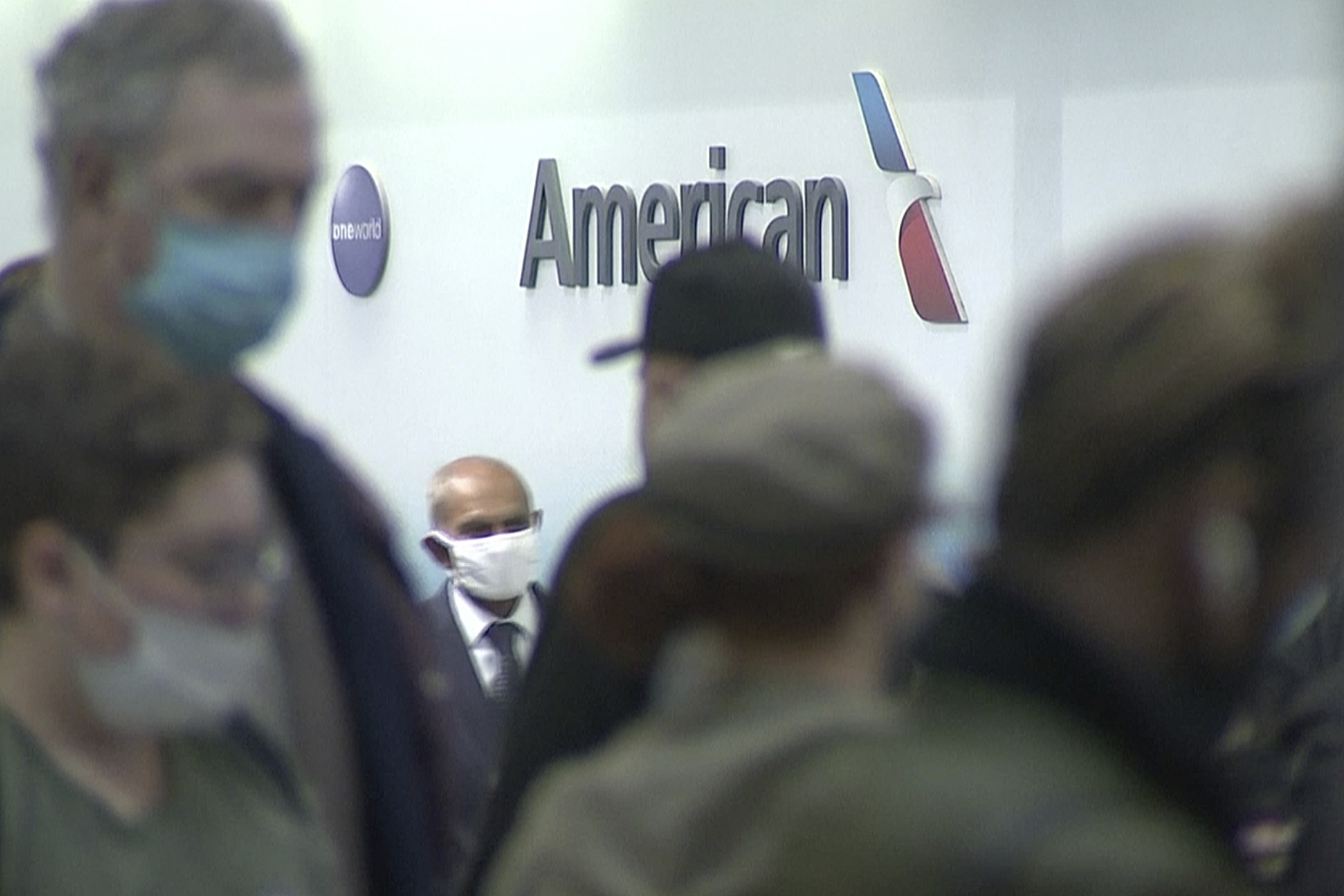 People wait in line at an American Airlines counter at an airport in Charlotte, N.C. on Sunday. The airline has canceled more than 800 flights on Sunday, or nearly 30% of its schedule for the day.