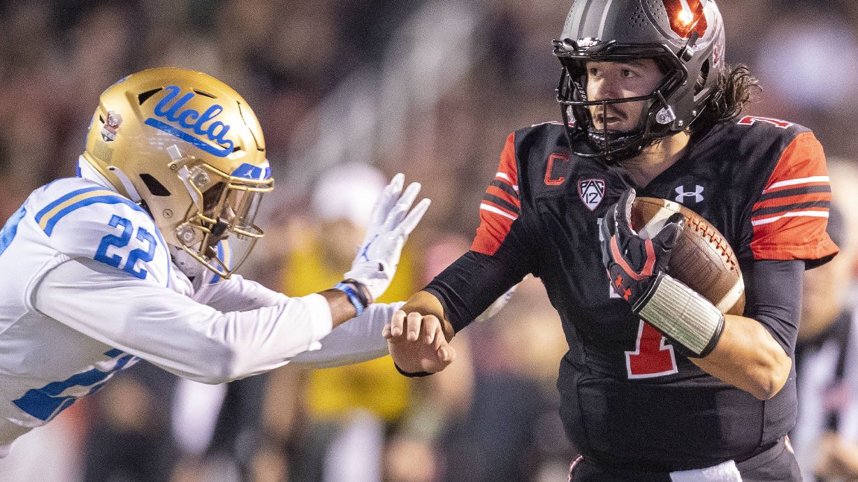 Utah Utes quarterback Cameron Rising (7) runs down the sideline trying to avoid the tackle from UCLA Bruins defensive back Obi Eboh (22) at Rice Eccles Stadium in Salt Lake City, Utah on Saturday, Oct. 30, 2021.