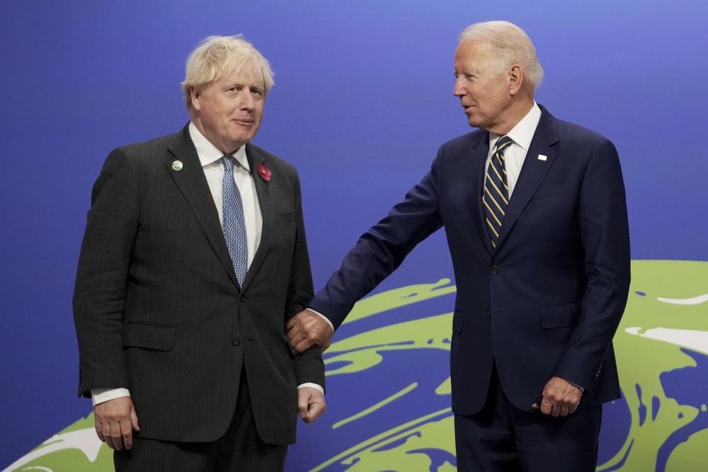 British Prime Minister Boris Johnson, left, greets U.S. President Joe Biden , at the COP26 U.N. Climate Summit in Glasgow, Scotland, Monday. The U.N. climate summit in Glasgow gathers leaders from around the world, in Scotland's biggest city, to lay out their vision for addressing the common challenge of global warming.