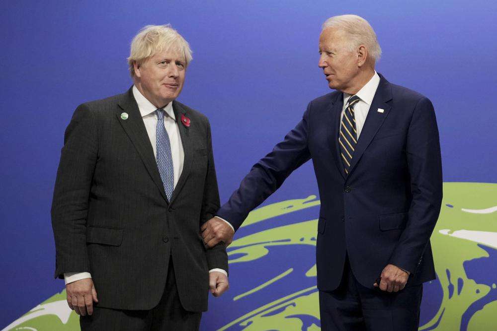 British Prime Minister Boris Johnson, left, greets U.S. President Joe Biden , at the COP26 U.N. Climate Summit in Glasgow, Scotland, Monday. The U.N. climate summit in Glasgow gathers leaders from around the world, in Scotland's biggest city, to lay out their vision for addressing the common challenge of global warming.