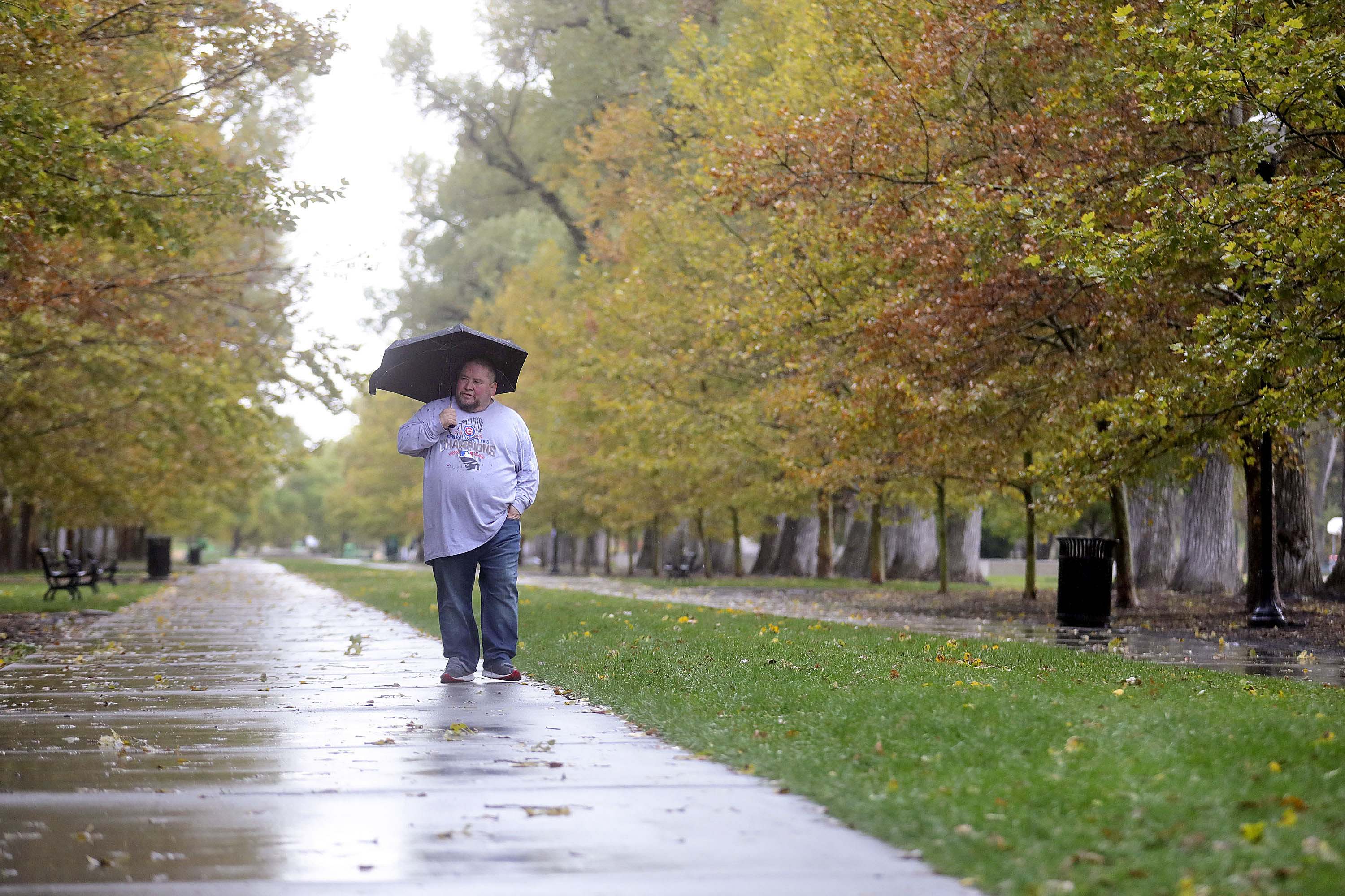 John Martinez walks in the rain at Liberty Park in Salt Lake City on Oct. 19. Last month ended up being the seventh-wettest October in city history.