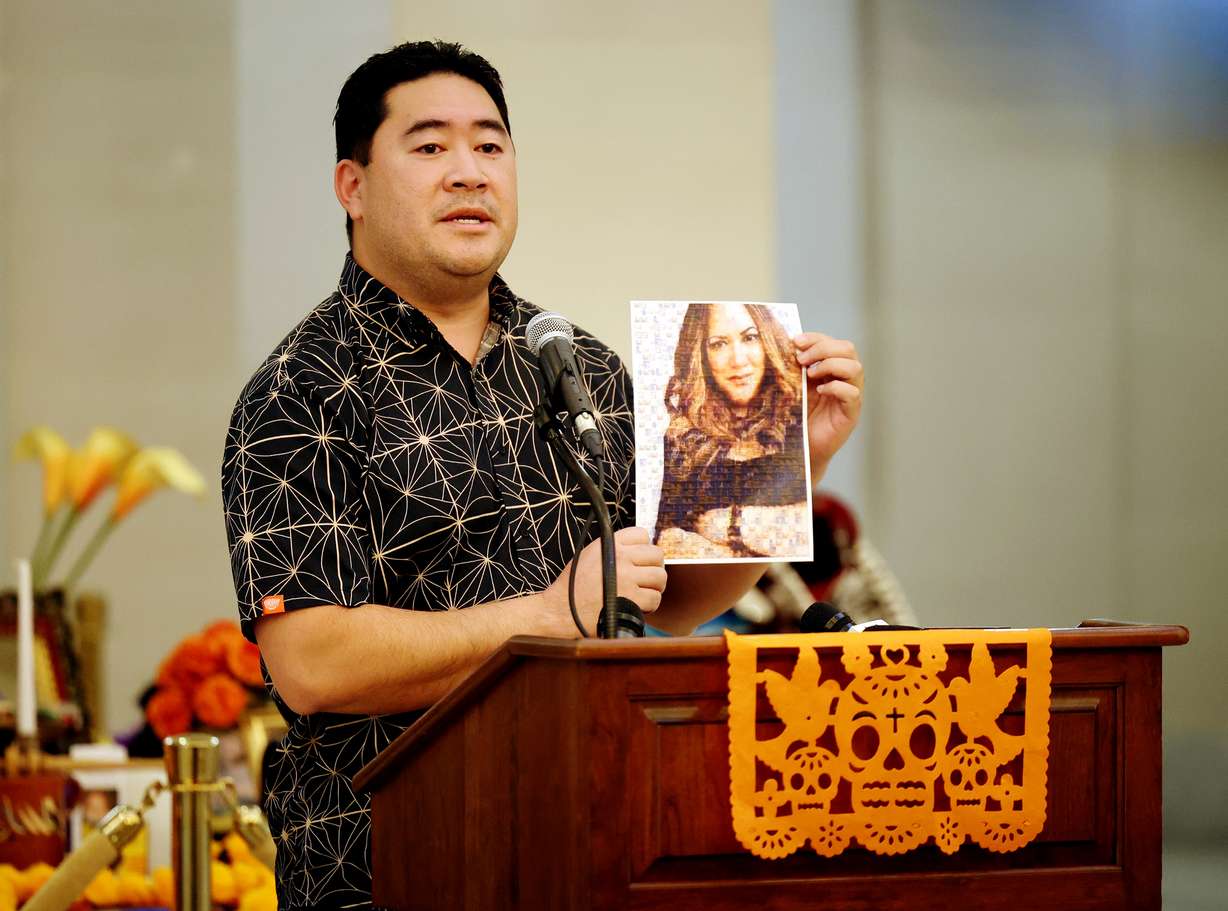 Jake Fitisemanu, chairman of the Utah Pacific Health Coalition, holds a photo of Margarita Satini, the late chairwoman of the Pacific Islander COVID-19 task force, during a remembrance event in honor of Día de los Muertos (Day of the Dead) in the Hall of Governors at the Capitol in Salt Lake City on Monday. Fitisemanu placed the photo among the others on display during the event hosted by the Utah Division of Multicultural Affairs and the Utah Department of Health.