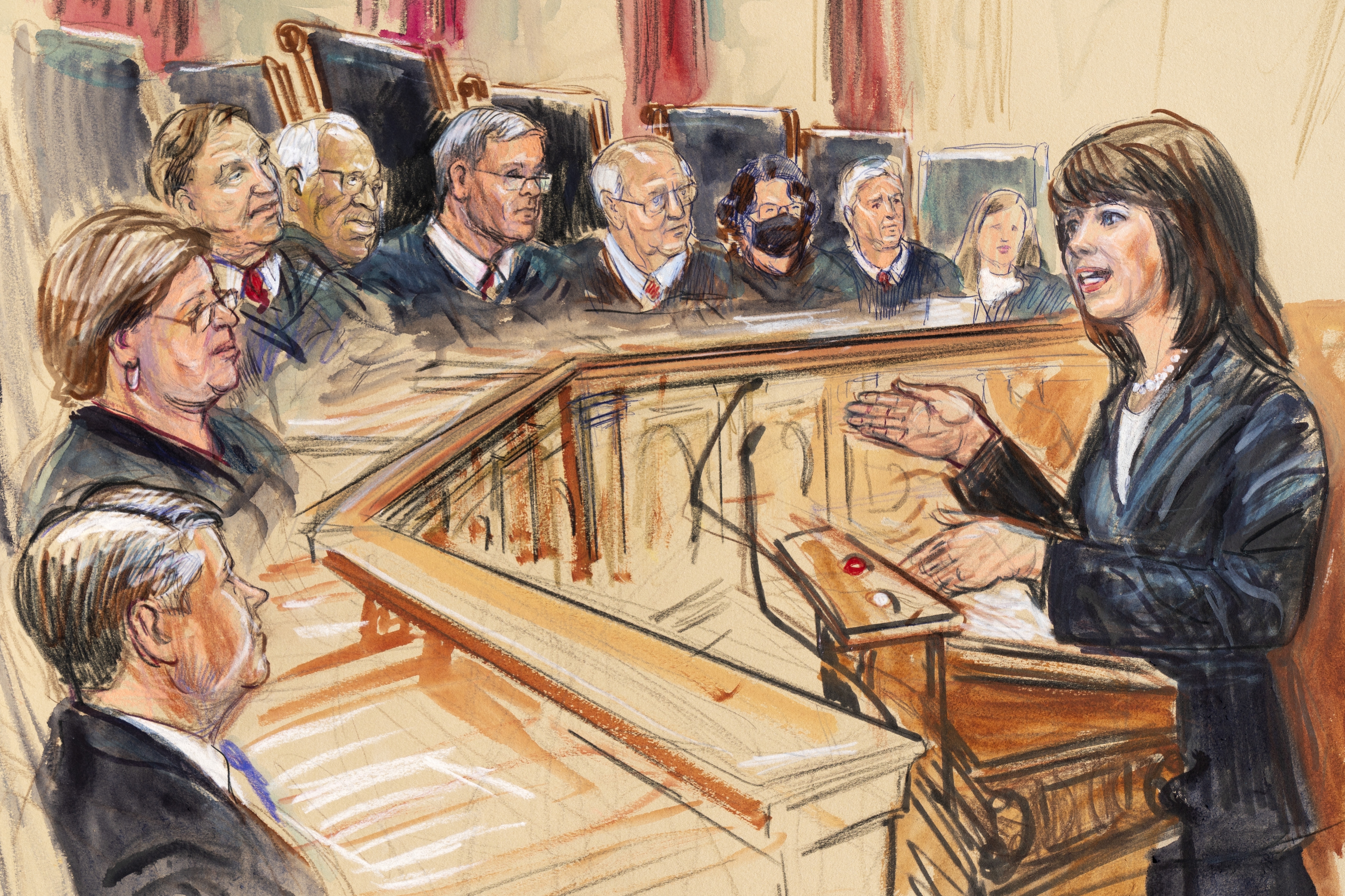 This artist sketch depicts Solicitor General Elizabeth Prelogar, right, presenting an argument before the Supreme Court, Monday, Nov. 1, 2021, in Washington. Justices seated from left are Associate Justice Brett Kavanaugh, Associate Justice Elena Kagan, Associate Justice Samuel Alito, Associate Justice Clarence Thomas, Chief Justice John Roberts, Associate Justice Stephen Breyer, Associate Justice Sonia Sotomayor, Associated Justice Neil Gorsuch and Associate Justice Amy Coney Barrett.