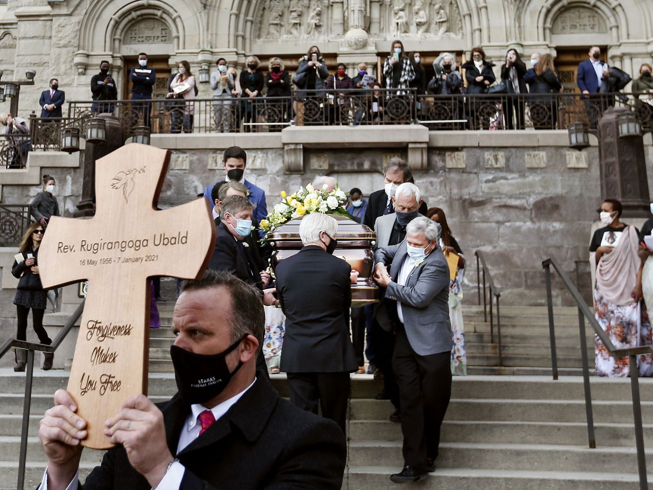 Father Ubald Rugirangoga’s casket is carried out of the
Cathedral of the Madeleine following his funeral in Salt Lake City
on Jan. 27. Father Ubald, a Roman Catholic priest from
Rwanda, died of COVID-19 at the University of Utah Hospital. The
world’s death toll from COVID-19 topped 5 million on Monday, a
staggering milestone that comes as cases continues to climb in
Utah.