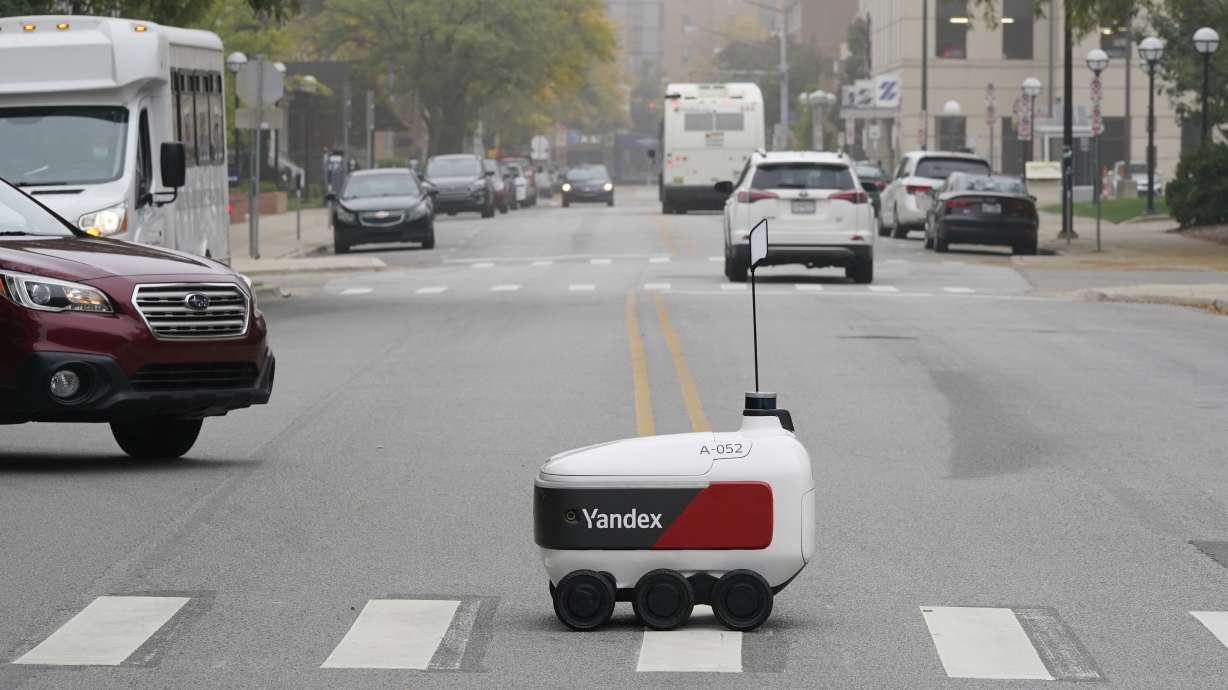 A food delivery robot crosses a street in Ann Arbor, Mich. on Oct. 7. Robot food delivery is no longer the stuff of science fiction.