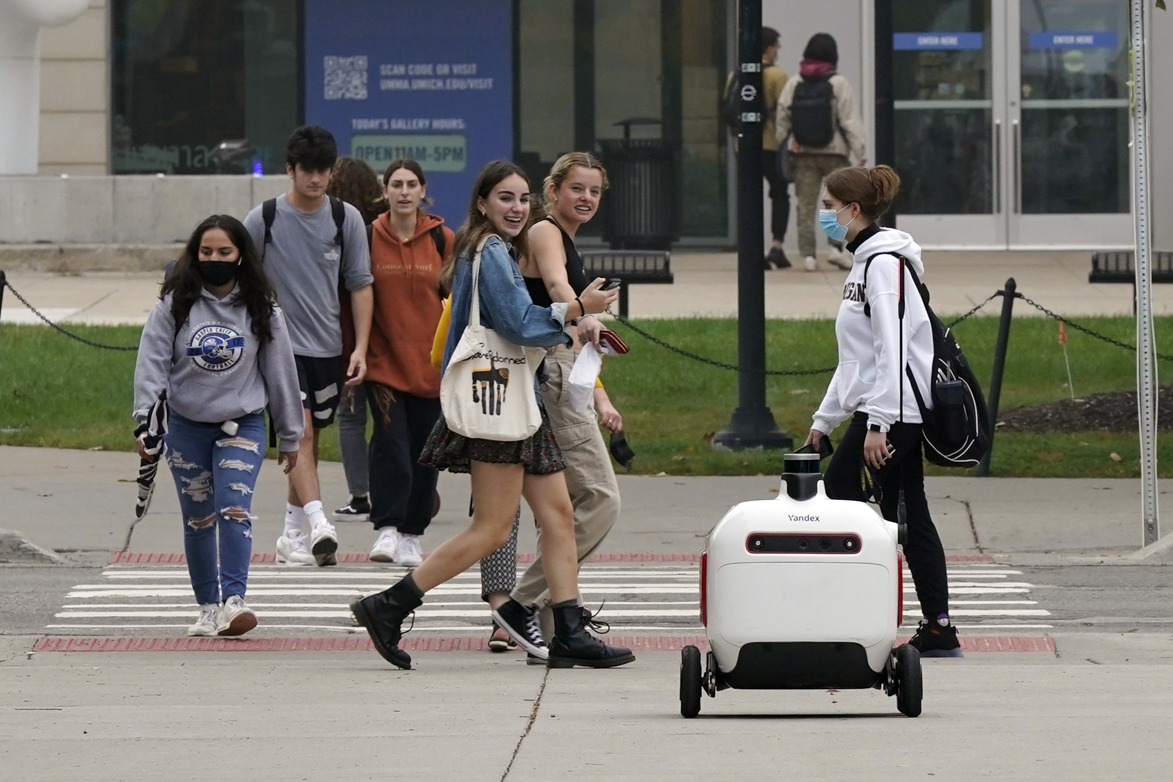 A food delivery robot crosses a street in Ann Arbor, Mich. on Oct. 7. Robot food delivery is no longer the stuff of science fiction.