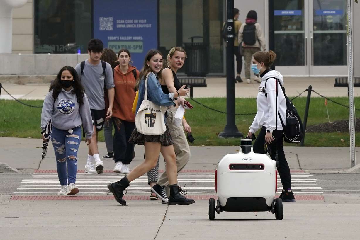 A food delivery robot crosses a street in Ann Arbor, Mich. on Oct. 7. Robot food delivery is no longer the stuff of science fiction.