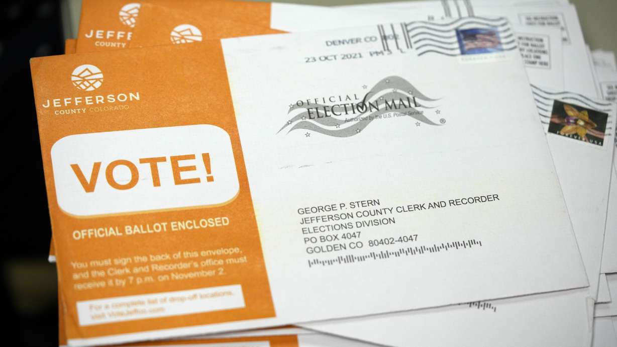 Early ballots wait to be processed by election judges in the Jefferson County, Colo., elections division, Tuesday, Oct. 26, in Golden, Colo. Officials were highlighting the steps taken to ensure that the election is carried out seamlessly.