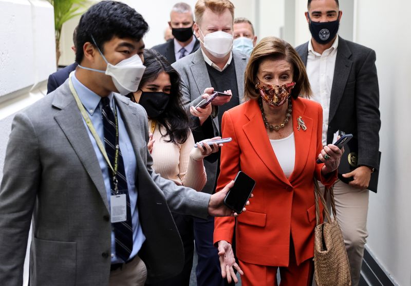 House Speaker Nancy Pelosi is pursued by reporters as she attends a House Democratic Caucus meeting at the Capitol in Washington on Tuesday.
