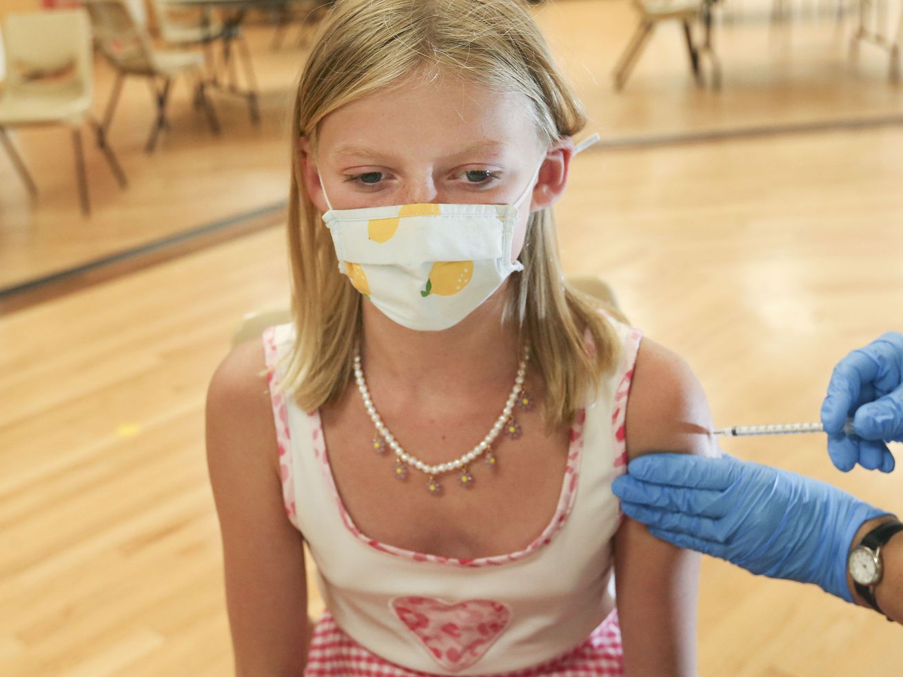Twelve-year-old Willa Carroll, of Sugar House, gets a
COVID-19 vaccination at the South Davis Senior Activity Center in
Bountiful on Aug. 25. COVID-19 vaccinations for
children as young as 5 years old could begin this week, now that
the shots are just a step away from final federal authorization and
millions of downsized doses are already on the way to Utah and
other states.