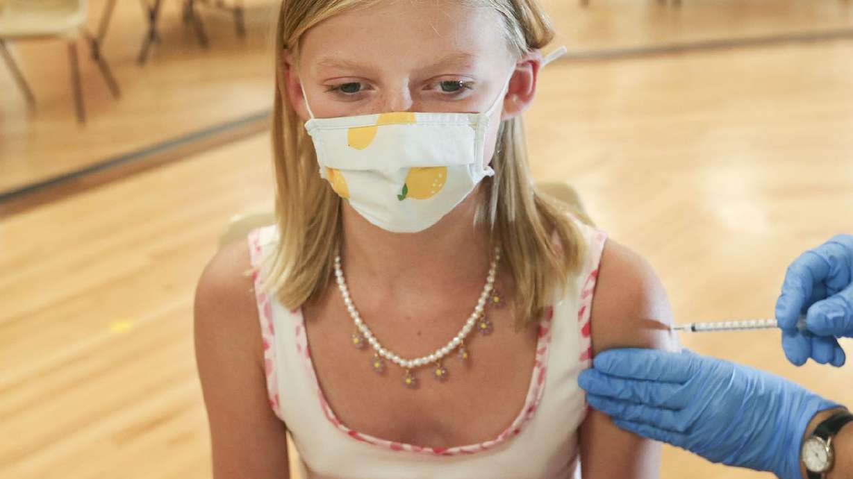 Twelve-year-old Willa Carroll, of Sugar House, gets a
COVID-19 vaccination at the South Davis Senior Activity Center in
Bountiful on Aug. 25. COVID-19 vaccinations for
children as young as 5 years old could begin this week, now that
the shots are just a step away from final federal authorization and
millions of downsized doses are already on the way to Utah and
other states.