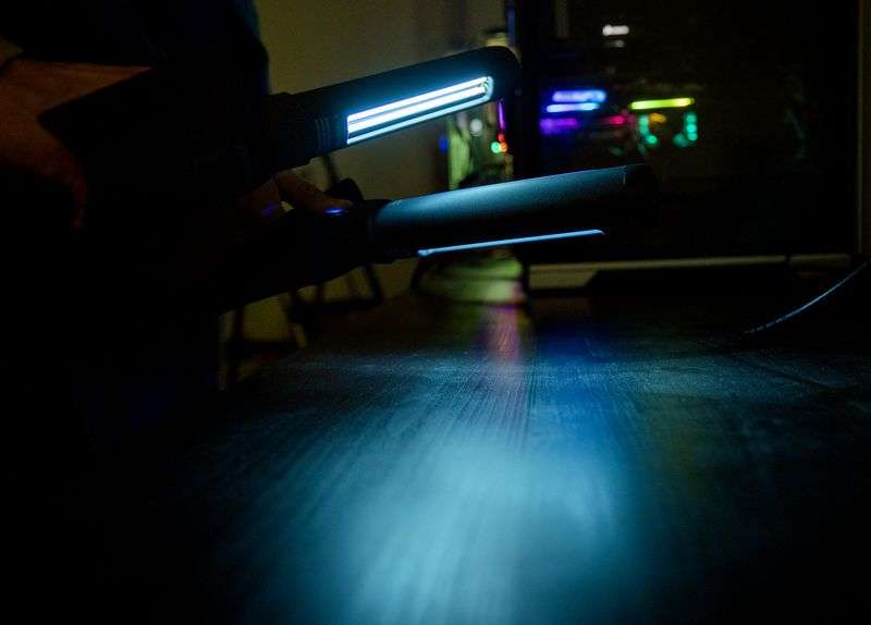 Dan Barnes, president and co-founder of PhoneSoap, and
Wes Laporte, the company’s CEO and co-founder, show off the
company’s newest product, the SurfaceSoap UV Wand, a portable,
hand-held device that disinfects hard surfaces with
bacteria-killing ultraviolet light, inside the company’s warehouse
in Provo on Tuesday, Nov. 2, 2021.