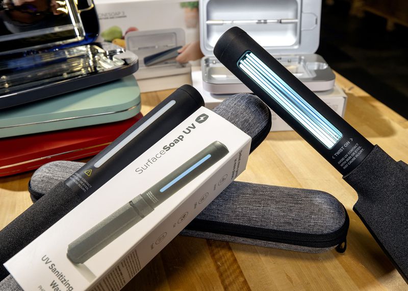 PhoneSoap’s SurfaceSoap UV Wand, a portable, hand-held
device that disinfects hard surfaces with bacteria-killing
ultraviolet light, is shown with other sanitizing products at the
company’s warehouse in Provo on Tuesday, Nov. 2, 2021.