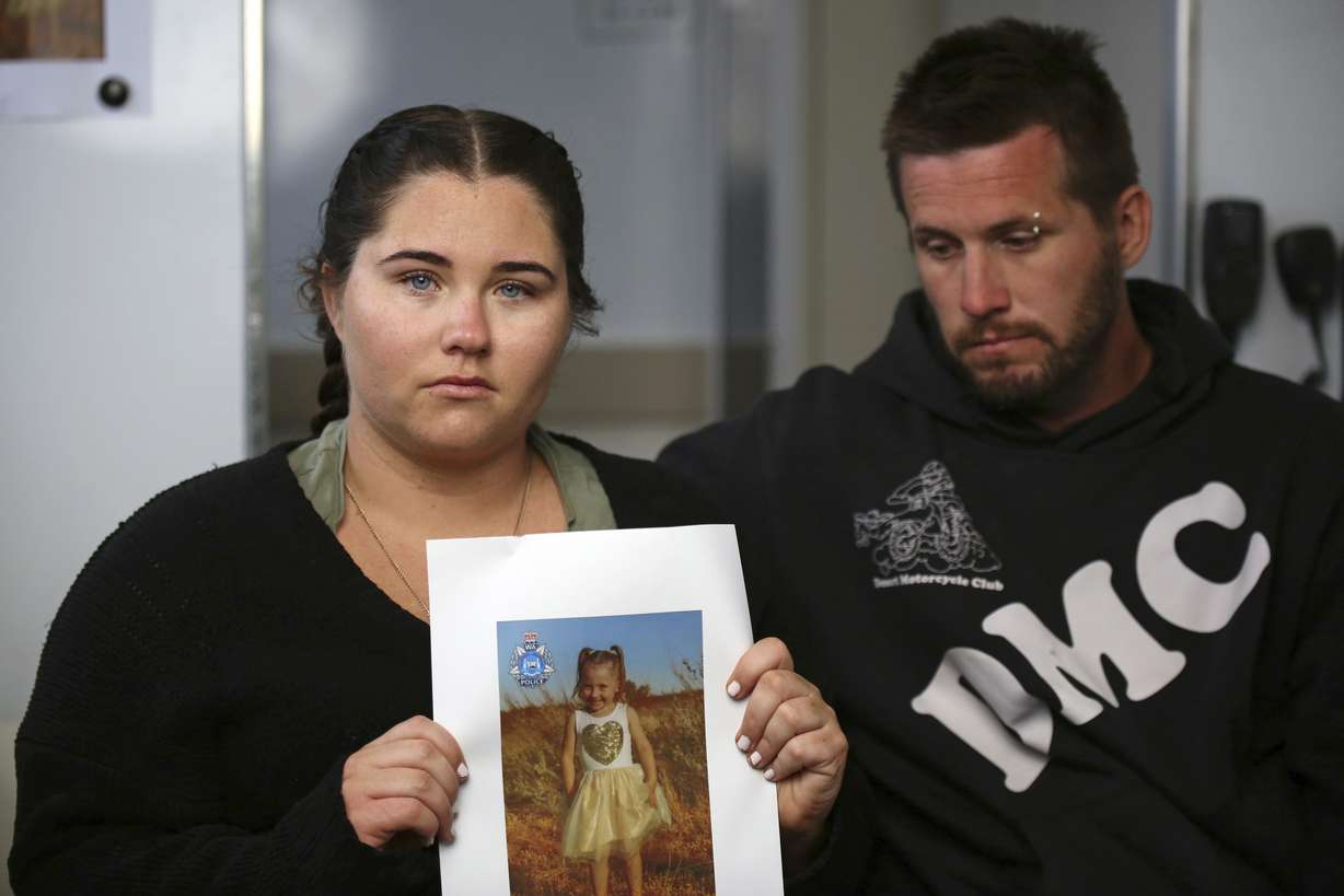 Ellie Smith, left, and her partner Jake Gliddon, display a photo of their missing daughter, Cleo, near Carnarvon in Western Australia state, Australia, Oct. 19.