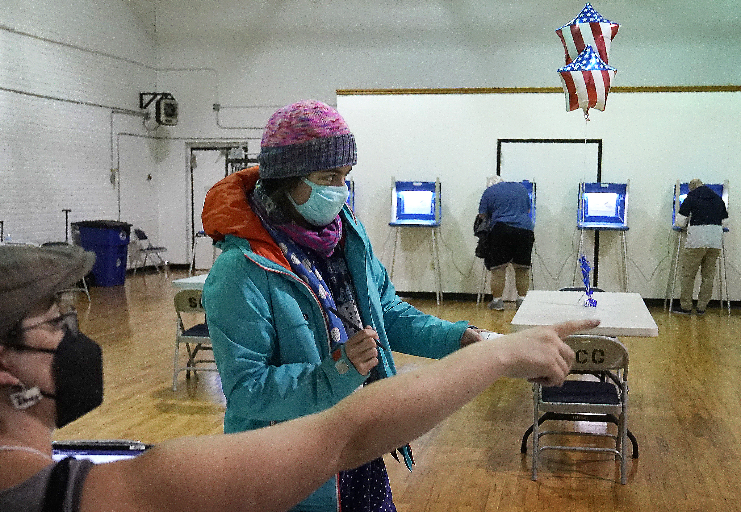 Monica Rojas gets directions from a poll worker on her way to casting her ballot at Sabathani Community Center during municipal elections Tuesday in Minneapolis. 