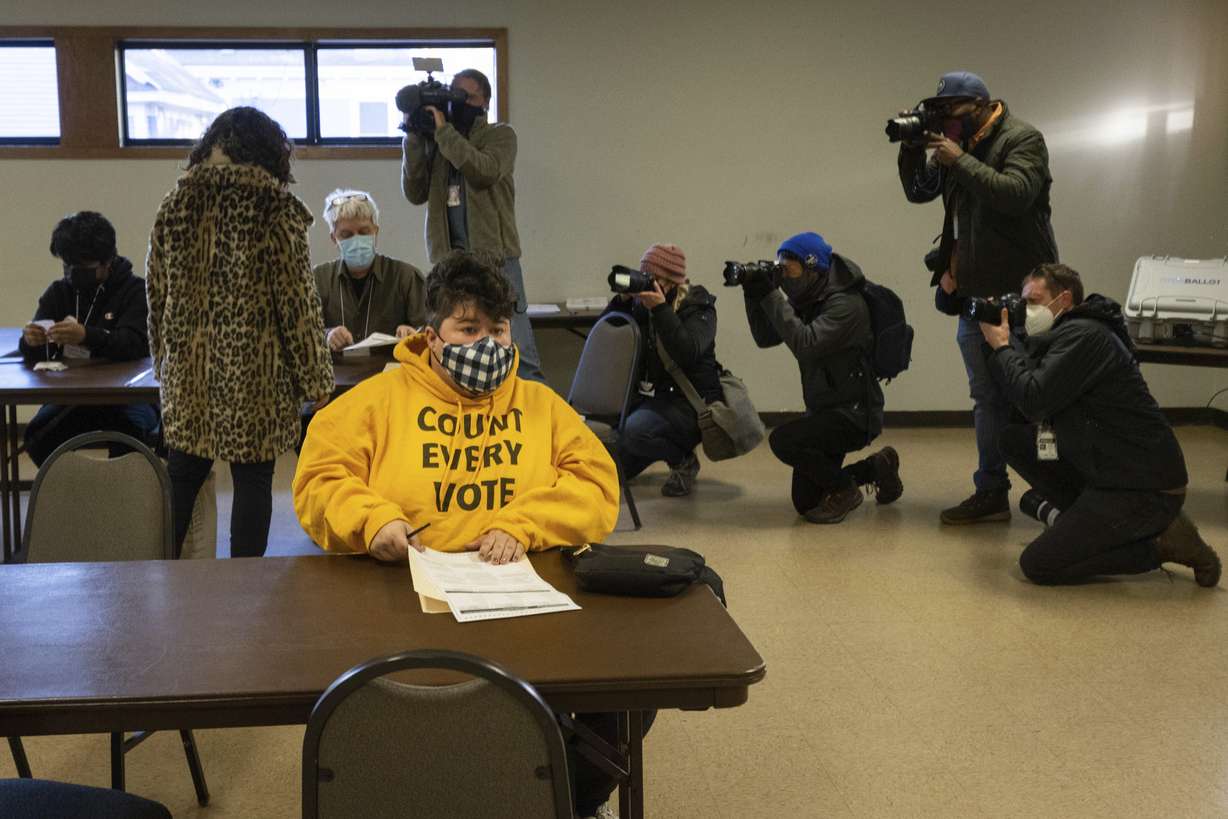 Photojournalists document mayoral candidate Sheila Nezhad as she walks into the Gichitwaa Kateri Catholic Church on Election Day to cast her vote on Tuesday in Minneapolis.
