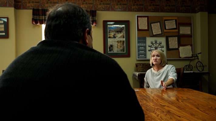 Gardner Village’s marketing director Marcia Johns shows KSL’s Matt Gephardt how an impostor lifted photos and posts from their Facebook page to create a fake page.