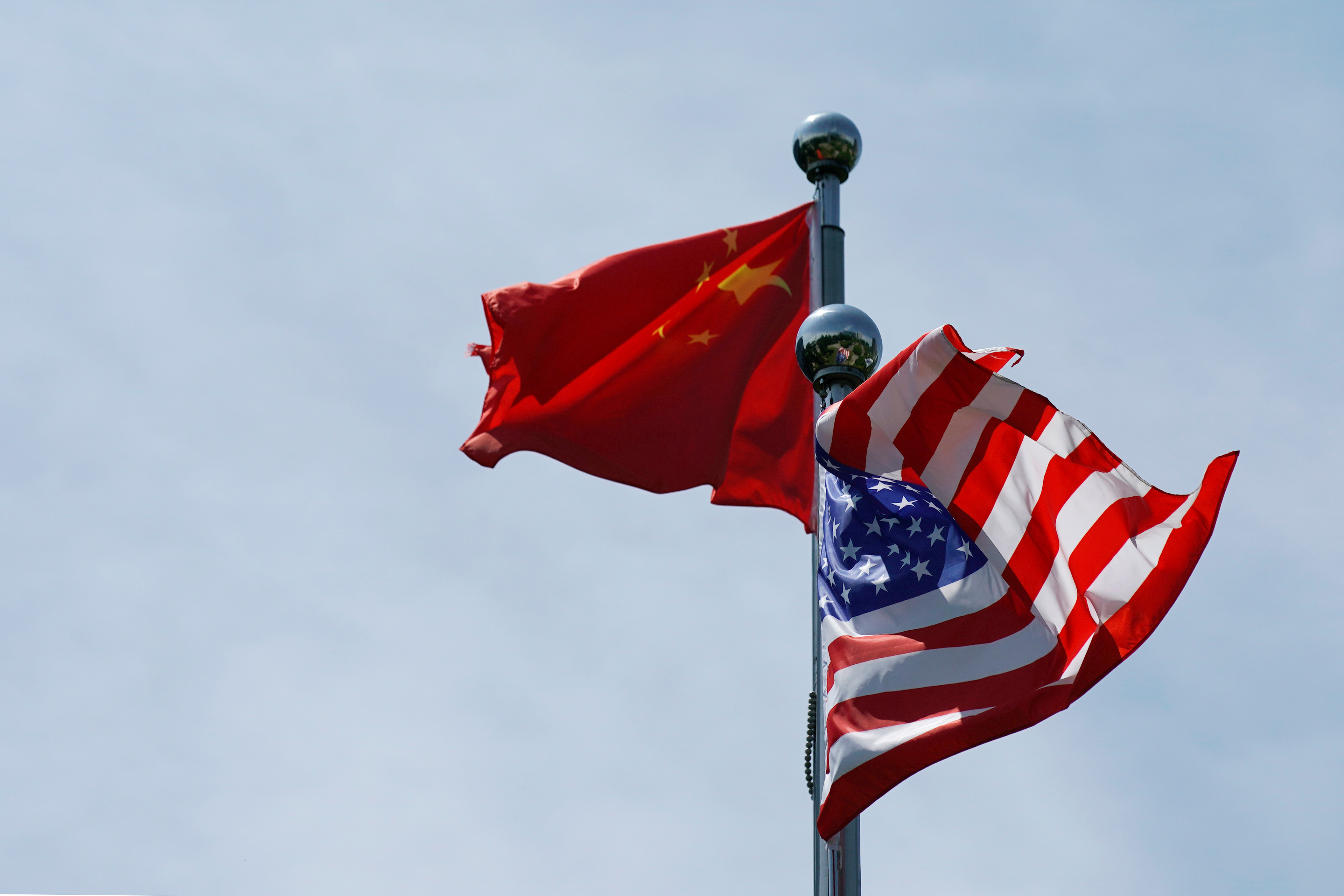 Chinese and U.S. flags flutter near The Bund, before trade talks in Shanghai, China, July 30, 2019. The Pentagon on Wednesday sharply increased its estimate of China's projected nuclear weapons arsenal, saying Beijing could have 700 warheads by 2027 and possibly 1,000 by 2030.

