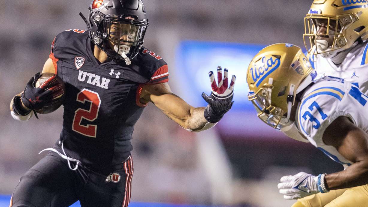 Utah Utes running back Micah Bernard (2) gets a hand up to block the pursuit of UCLA Bruins defensive backs Quentin Lake (37) and Qwuantrezz Knight (24) during the second half of the Utah vs. UCLA game at Rice Eccles Stadium in Salt Lake City on Saturday, Oct. 30, 2021.
