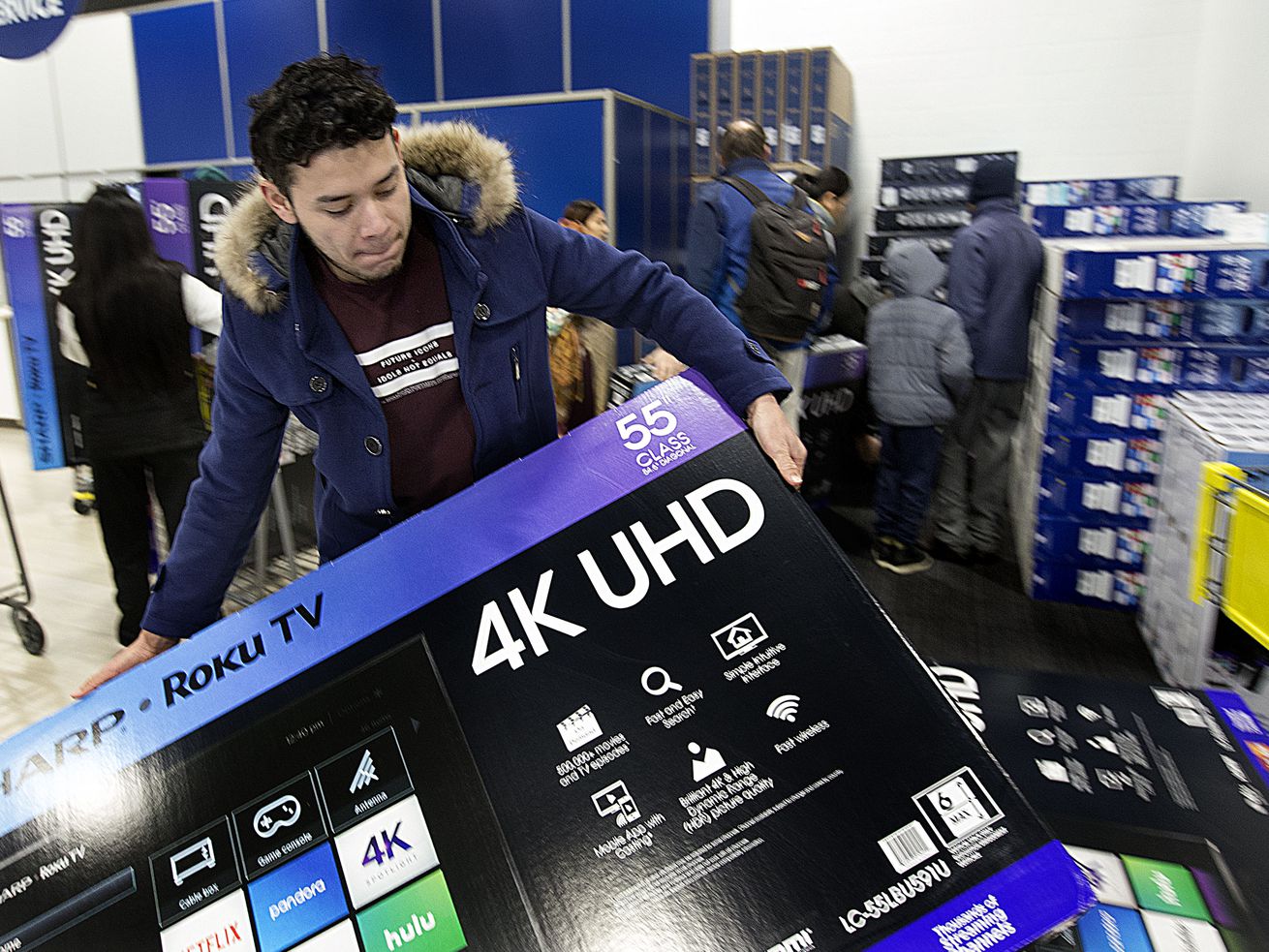 Kevin Castano purchases a television at Best Buy in
Salt Lake City on Nov. 23, 2018. Labor shortages and supply
chain issues may be driving up prices on consumer goods and could
lead to some must-have gifts becoming difficult or impossible to
get a hold of.