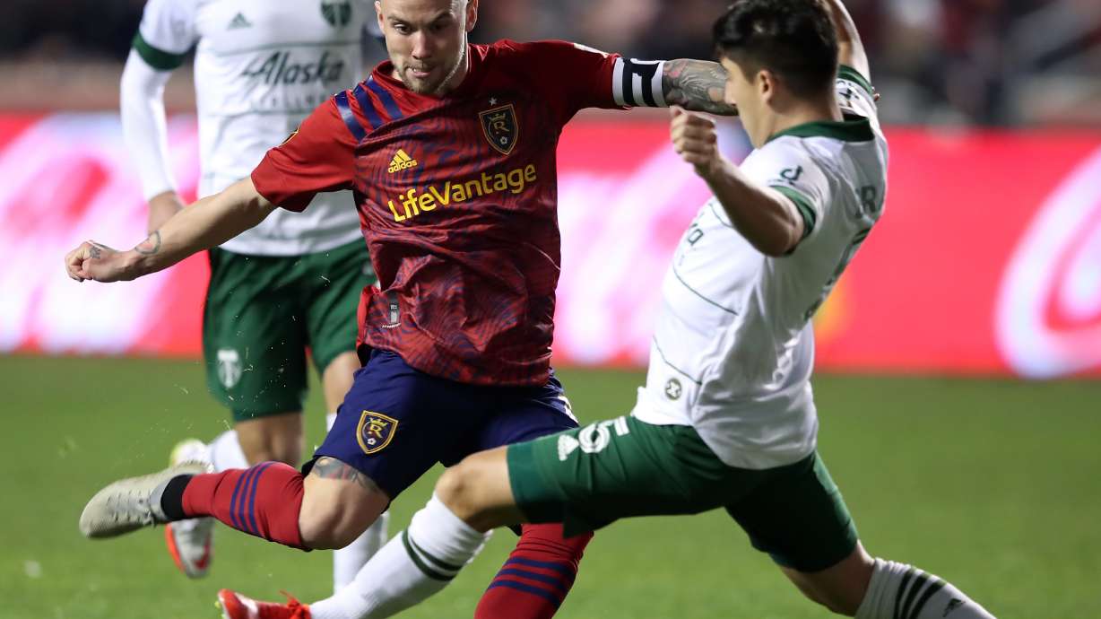 Real Salt Lake midfielder Albert Rusnak (11) tries to kick the ball past Portland Timbers defender Claudio Bravo (5) as Real Salt Lake and the Portland Timbers play at Rio Tinto Stadium in Sandy Wednesday, Nov. 3, 2021. Portland Timbers won 3-1.