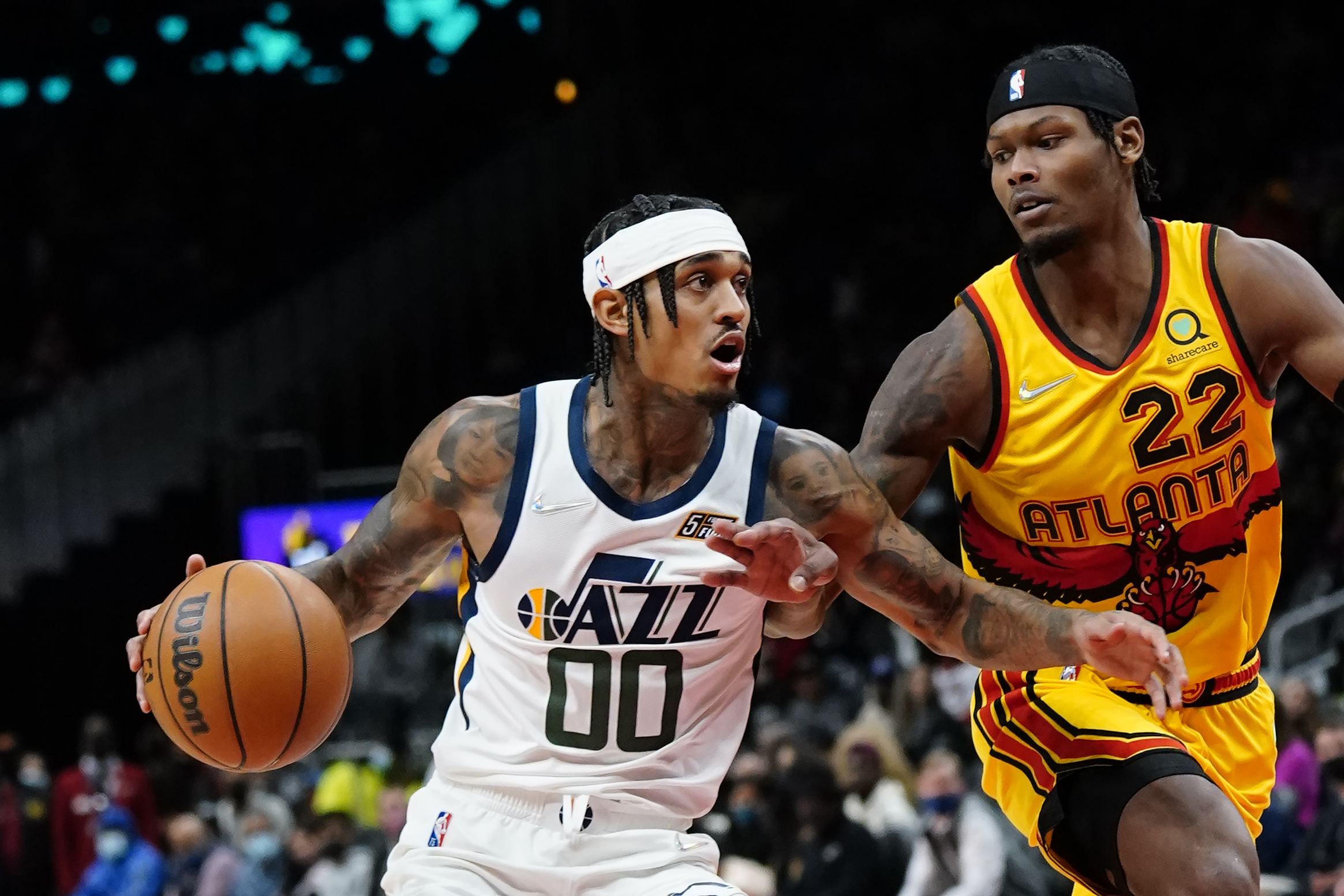 Utah Jazz guard Jordan Clarkson (00) drives as Atlanta Hawks forward Cam Reddish (22) defends during the first half of an NBA basketball game Thursday, Nov. 4, 2021, in Atlanta.