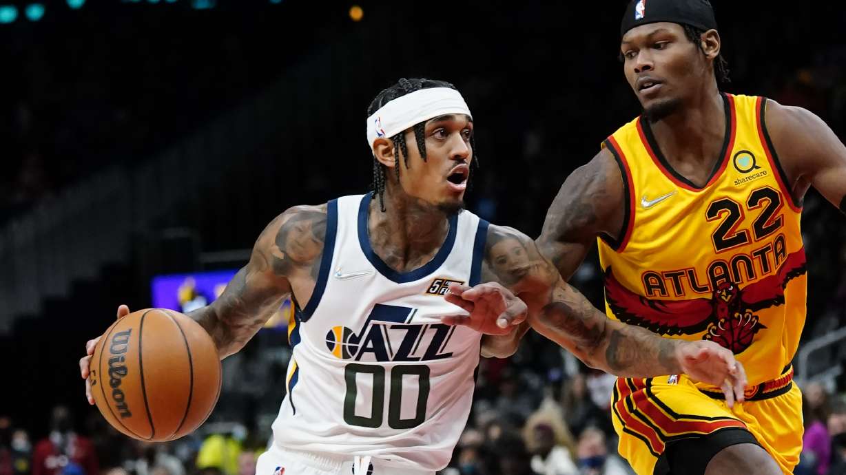 Utah Jazz guard Jordan Clarkson (00) drives as Atlanta Hawks forward Cam Reddish (22) defends during the first half of an NBA basketball game Thursday, Nov. 4, 2021, in Atlanta.