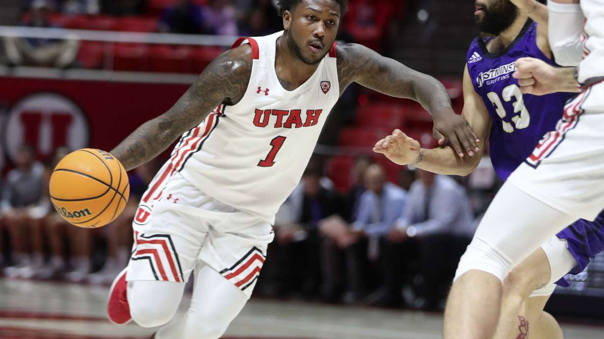 Utah Utes guard David Jenkins Jr. (1) drives against Westminster’s Jarrett Jordan at the Huntsman Center in Salt Lake City on Thursday, Nov. 4, 2021.