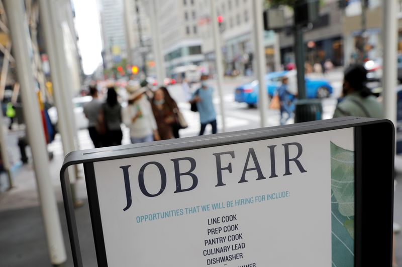 Signage for a job fair is seen in Manhattan, New York, Sept. 3. U.S. employment increased more than expected in October, the government reported Friday.