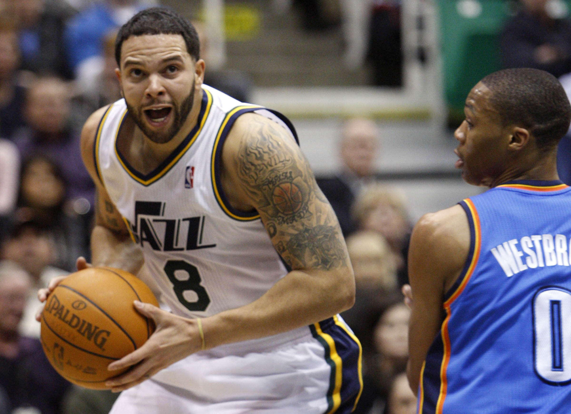 Deron Williams #8 of the Utah Jazz drives past Oklahoma City's #0 Russell Westbrook as the Utah Jazz play the Oklahoma City Thunder Saturday, Feb. 5, 2011 at Energy Solutions Arena.