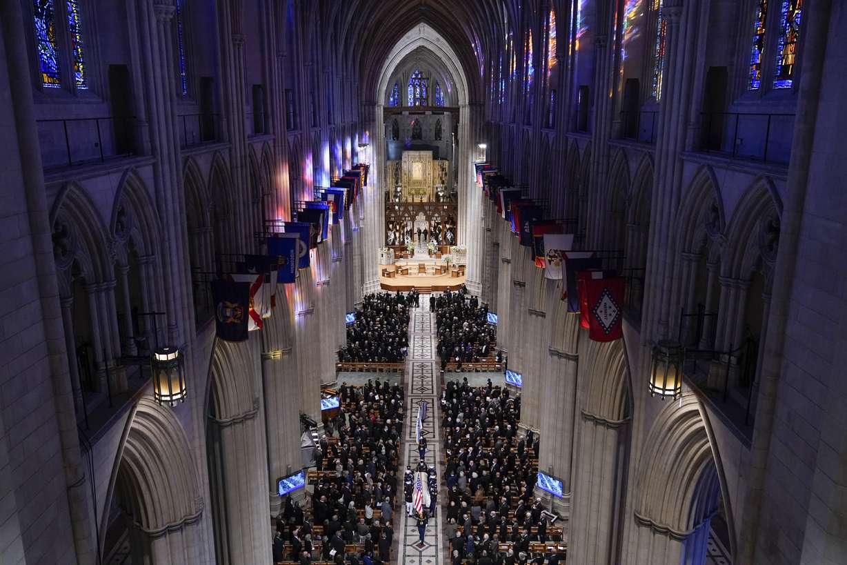 A military bearer team carries the casket after the funeral for former Secretary of State Colin Powell at the Washington National Cathedral, in Washington, Friday.