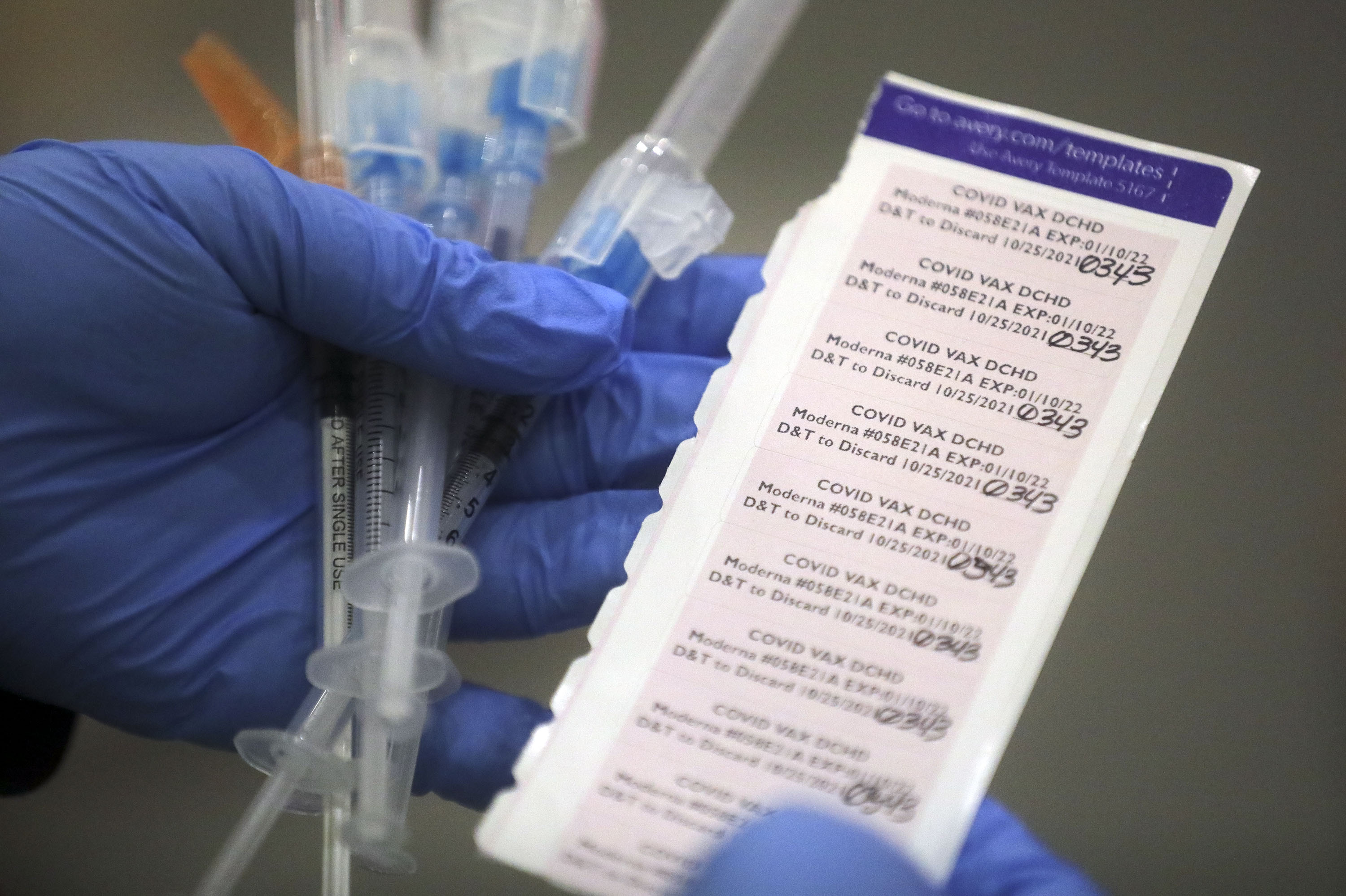 Davis County community health nurse Charmina Nandkeshwar carries booster doses of the Moderna COVID-19 vaccine at the Legacy Events Center in Farmington on Oct. 25.The Utah Department of Health reported 1,874 new COVID-19 cases and 10 deaths on Friday,