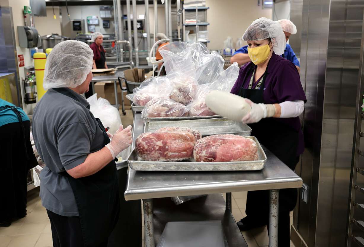 Workers process food for schools at Bates Central Kitchen, the Granite School District's central kitchen and warehouse, in West Valley City on Friday.