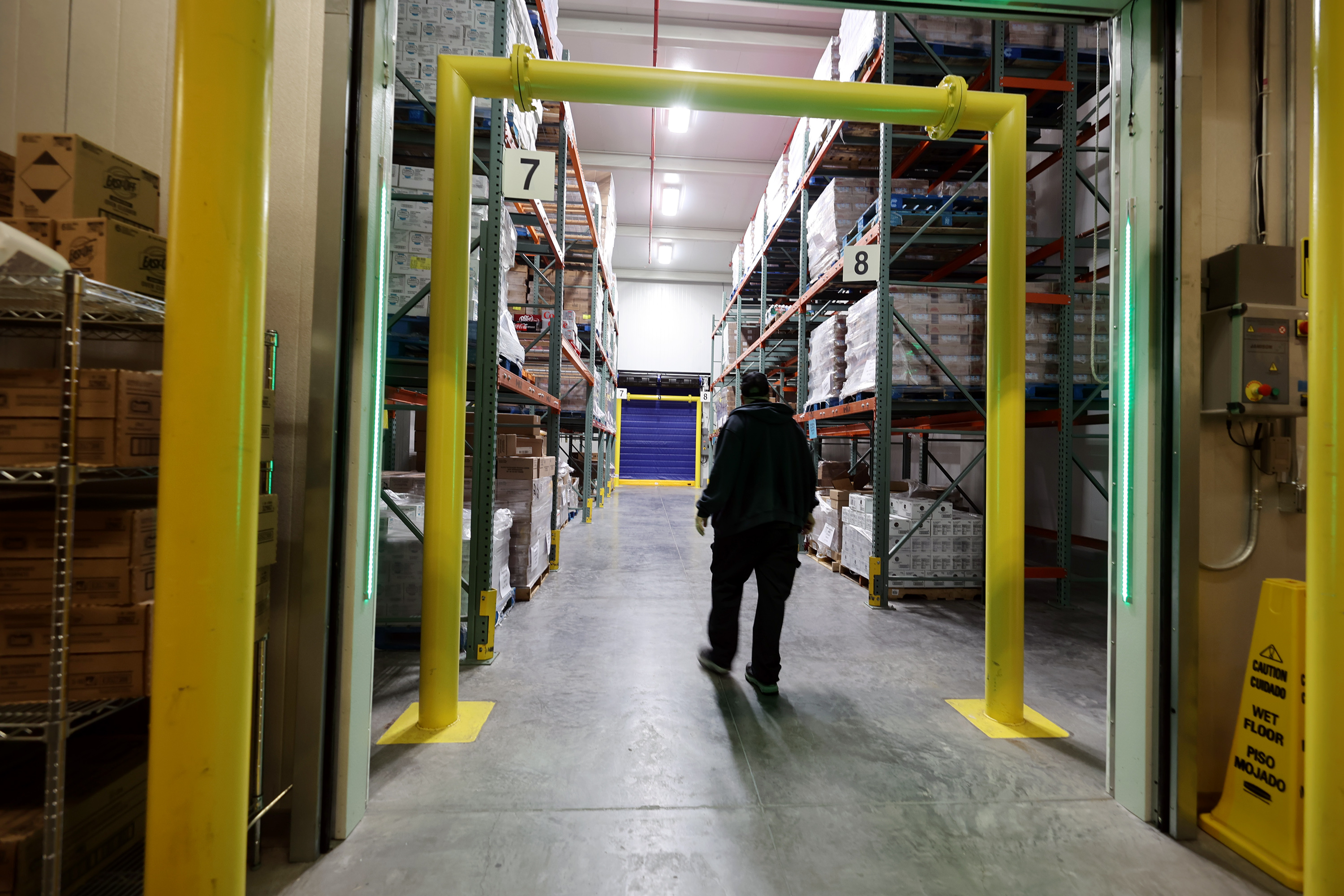 A worker walks into a freezer at Bates Central Kitchen, the Granite School District's central kitchen and warehouse, in West Valley City on Friday.
