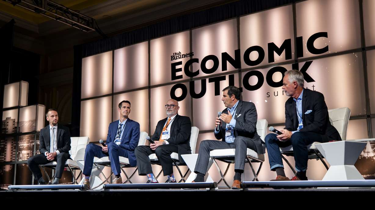 Stephen LeFevre, director of strategic and foreign affairs for World Trade Center Utah, left, moderates a discussion on supply chain issues and the impact on local businesses during the Utah Business Economic Outlook Summit at the Grand America Hotel in Salt Lake City on Friday.