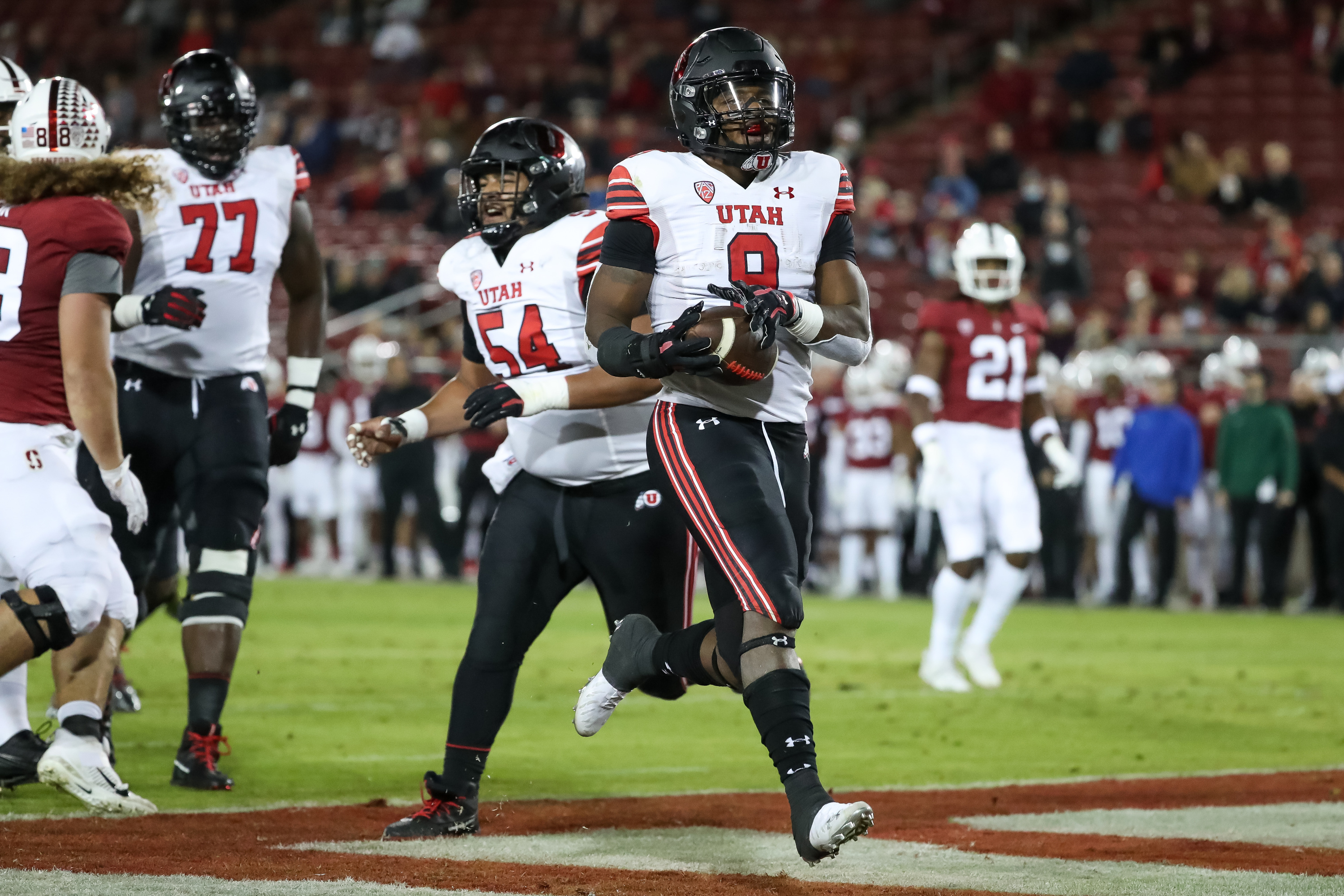 Utah Utes running back Tavion Thomas (9) runs in for his second touchdown, putting the Utes up 14-0 over the Stanford Cardinal after the PAT, in Stanford, Calif. on Friday, Nov. 5, 2021.