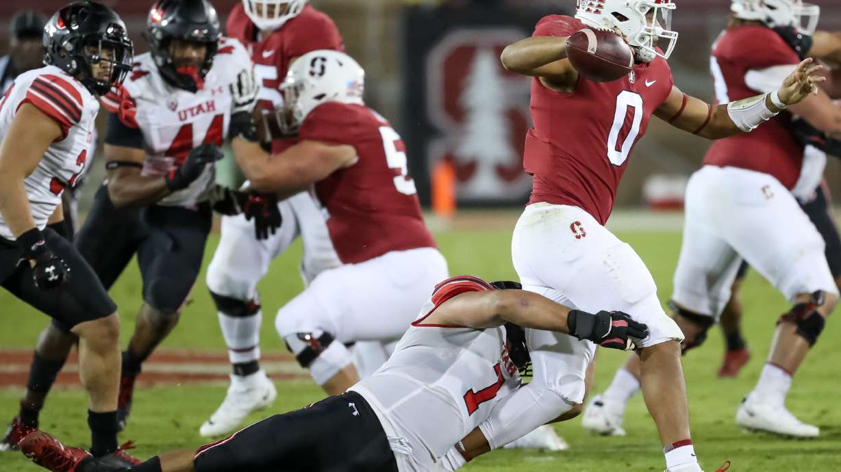 Stanford Cardinal quarterback Isaiah Sanders (0) is forced to throw the ball away under pressure from Utah Utes defensive end Van Fillinger (7) in Stanford, Calif. on Friday, Nov. 5, 2021.