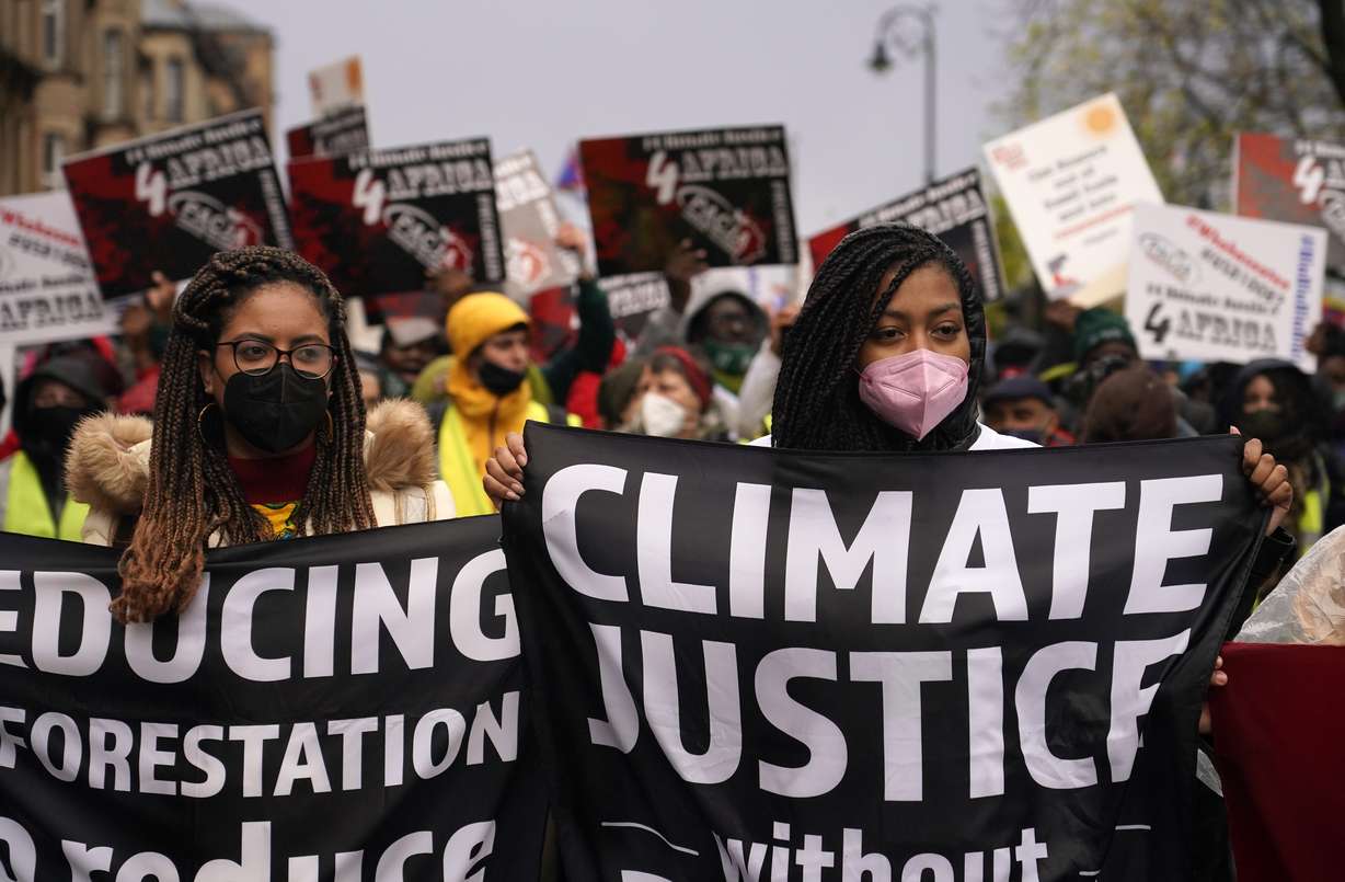 Climate activists hold up banners during a protest organized by the Cop26 Coalition in Glasgow, Scotland, Saturday, which is the host city of the COP26 U.N. Climate Summit. The protest was taking place as leaders and activists from around the world were gathering in Scotland's biggest city for the U.N. climate summit, to lay out their vision for addressing the common challenge of global warming.