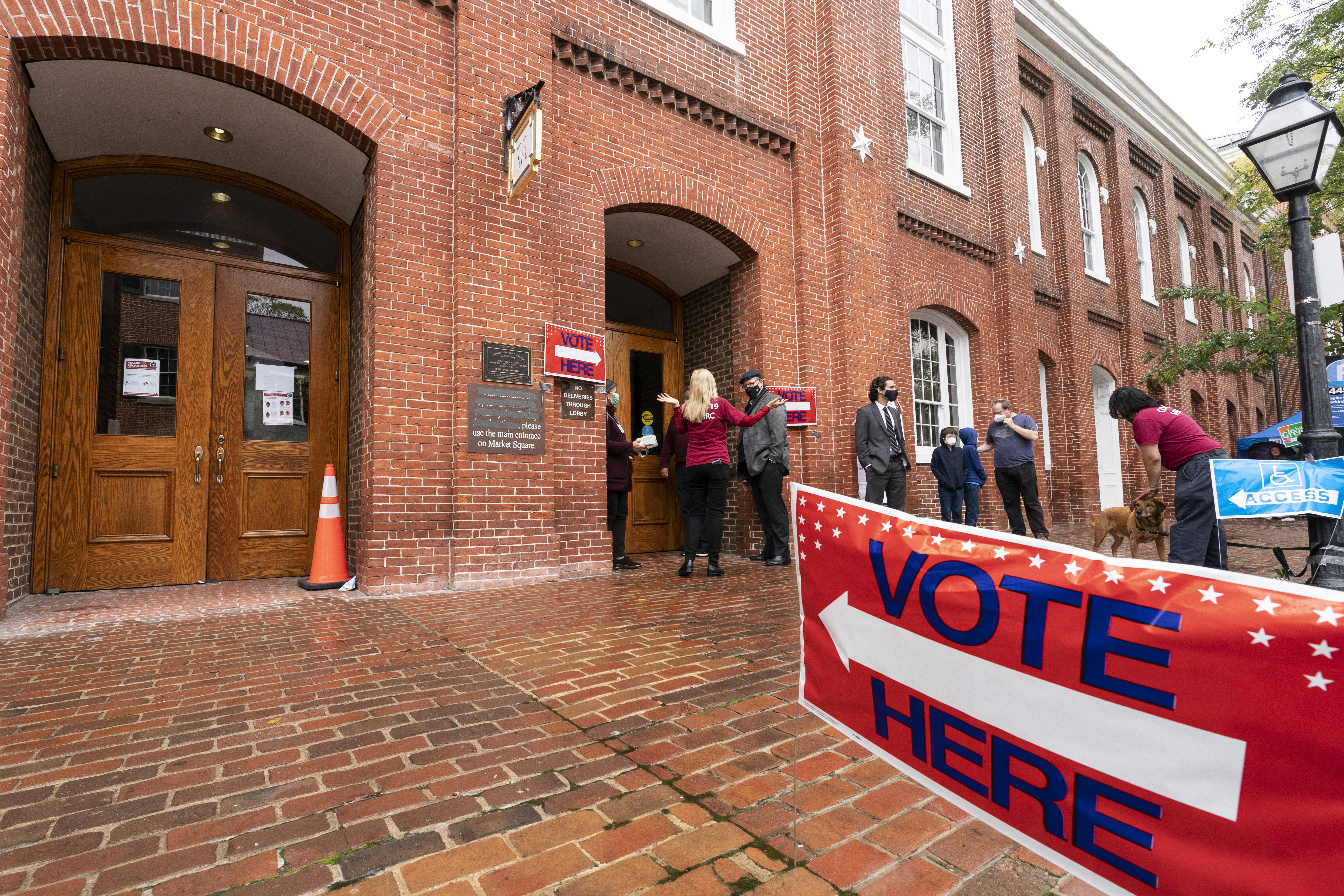 Voters arrive to cast their ballots on Election Day at City Hall, Tuesday, in Alexandria, Va. 