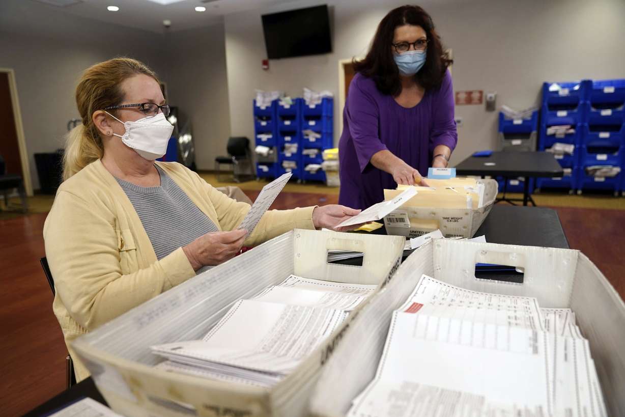 Board worker Ann Carlette, left, processes and double-checks mail-in ballots for Bergen County in Hackensack, N.J., Wednesday.