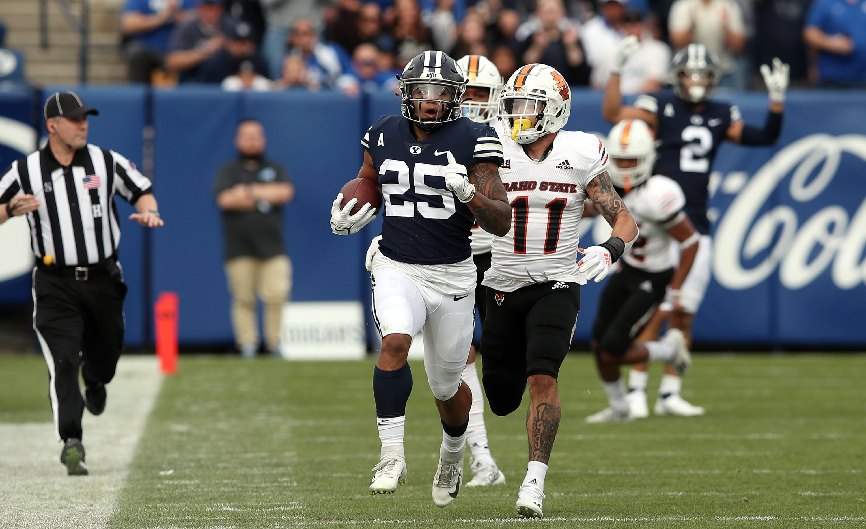 Brigham Young Cougars running back Tyler Allgeier (25) runs in the open field as Idaho State Bengals linebacker Oshea Trujillo (11) runs up from behind to make the touchdown saving tackle as BYU Cougars and the Idaho State Bengals play at LaVell Edwards Stadium in Provo on Saturday, Nov. 6, 2021.