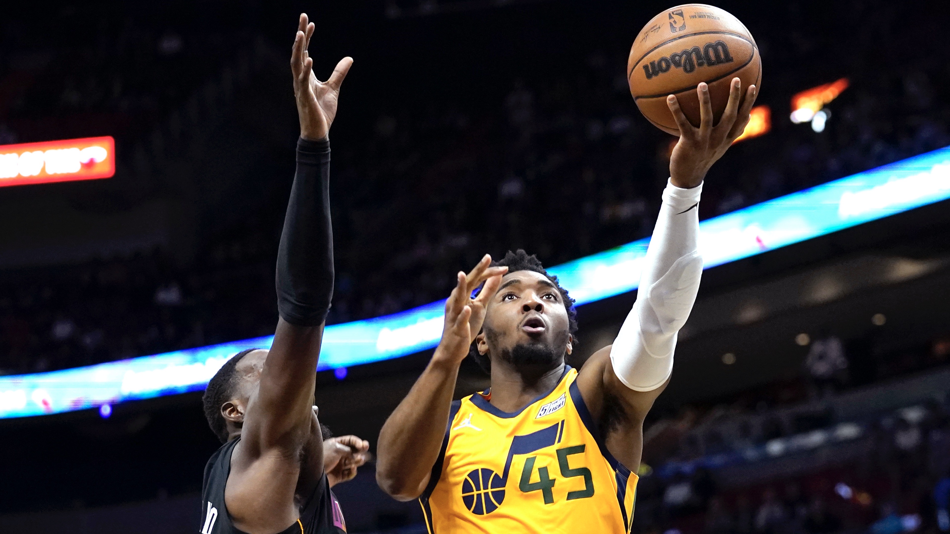 Utah Jazz guard Donovan Mitchell (45) goes to the basket as Miami Heat center Bam Adebayo defends during the first half of an NBA basketball game, Saturday, Nov. 6, 2021, in Miami.


