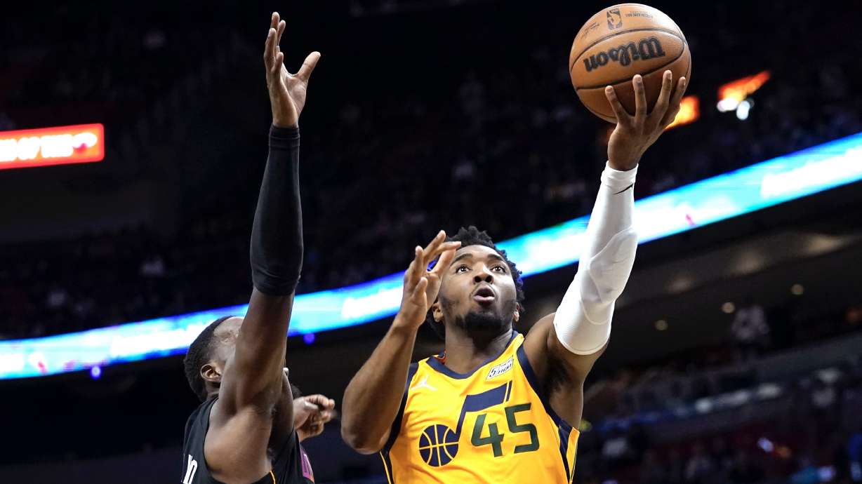 Utah Jazz guard Donovan Mitchell (45) goes to the basket as Miami Heat center Bam Adebayo defends during the first half of an NBA basketball game, Saturday, Nov. 6, 2021, in Miami.