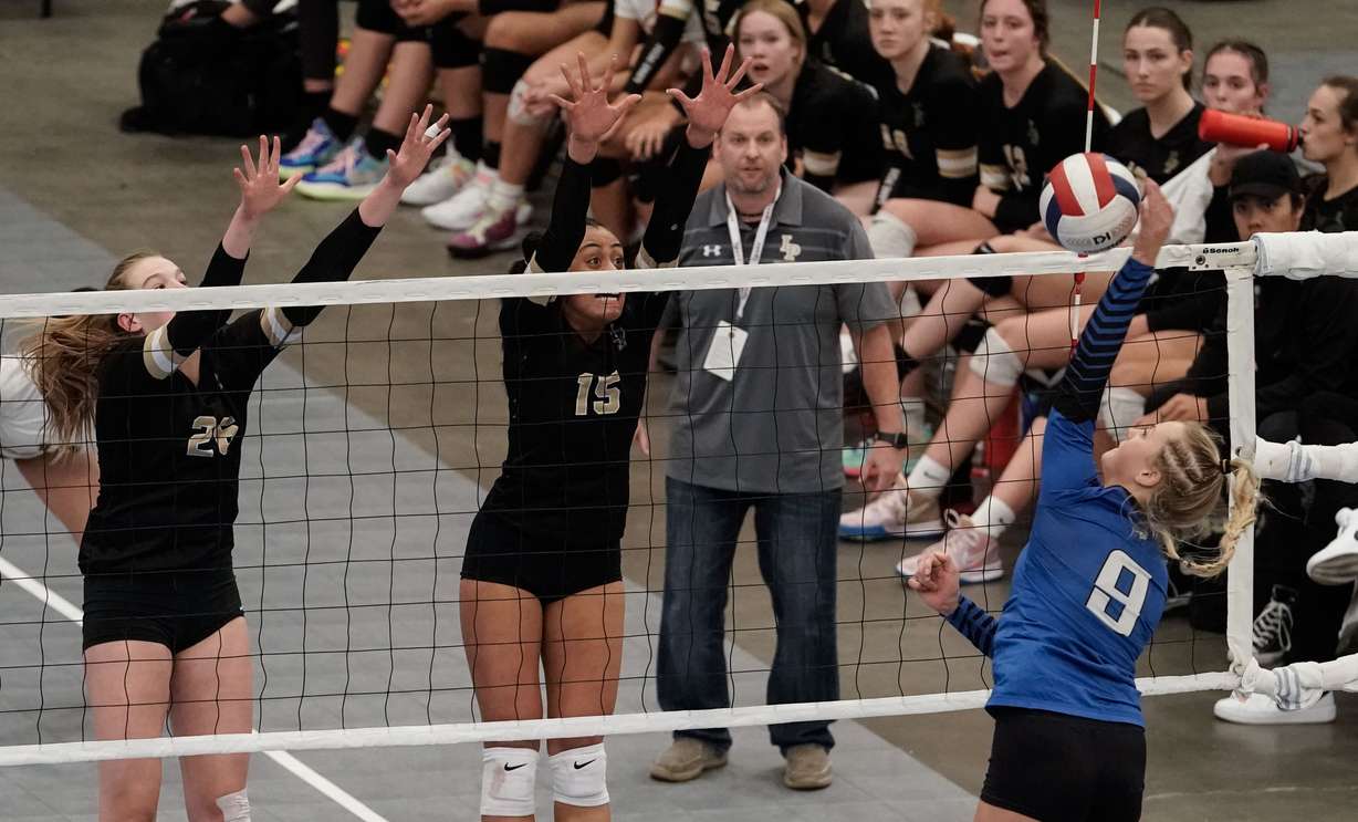 Pleasant Grove’s Hannah Olsen (8) hits the ball as Lone Peak’s Jayda Tupea, right and Kinley Swan reaches for a block in the 6A volleyball state championship on Saturday, Nov. 6, 2021 at UCCU Center in Orem .